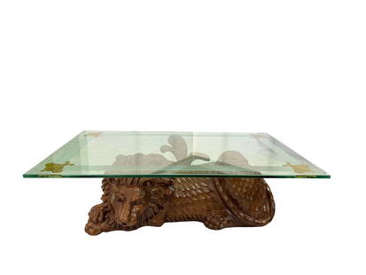 Ornate Carved Wood Lion Base Glass Coffee Table: Ornate Carved Wood Lion Base Glass Coffee Table - A striking and regal centerpiece, this handcrafted coffee table features a stunning lion base meticulously carved from solid wood. The lion is depicte