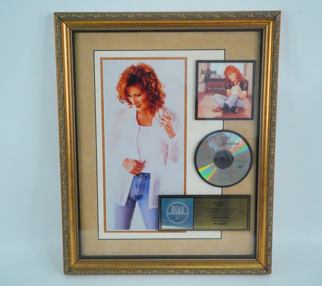 Jo Dee Messina "I'm Alright" RIAA Gold Sales Award: Jo Dee Messina "I'm Alright" RIAA Gold Sales Award Plaque Presented to WMUS Radio - This framed and matted display commemorates the RIAA-certified Gold sales milestone for Jo Dee Messina's 1998 hit al
