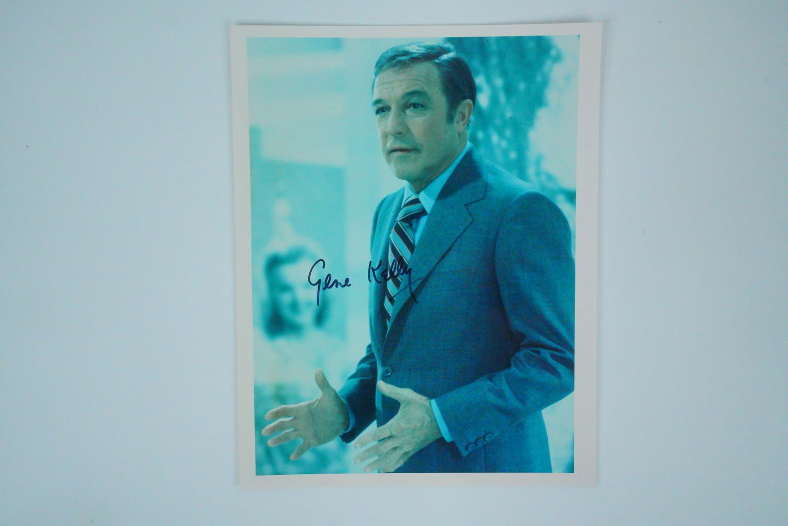 Gene Kelly Signed 8" x 10" Color Photograph: Gene Kelly Signed 8" x 10" Color Photograph - This striking 8" x 10" color photograph captures the legendary Gene Kelly in a later career moment, dressed in a classic suit and tie, exuding the charism