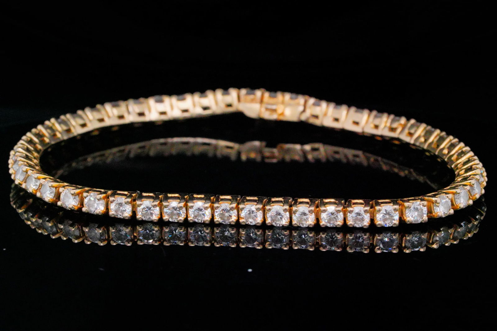 5.00ctw Diamond and 14K Yellow Gold Tennis Bracelet: 5.00ctw Diamond and 14K Yellow Gold 7" Tennis Bracelet - This classic tennis bracelet showcases approximately 5.00 carats of round brilliant diamonds, offering bright, lively sparkle throughout. Each