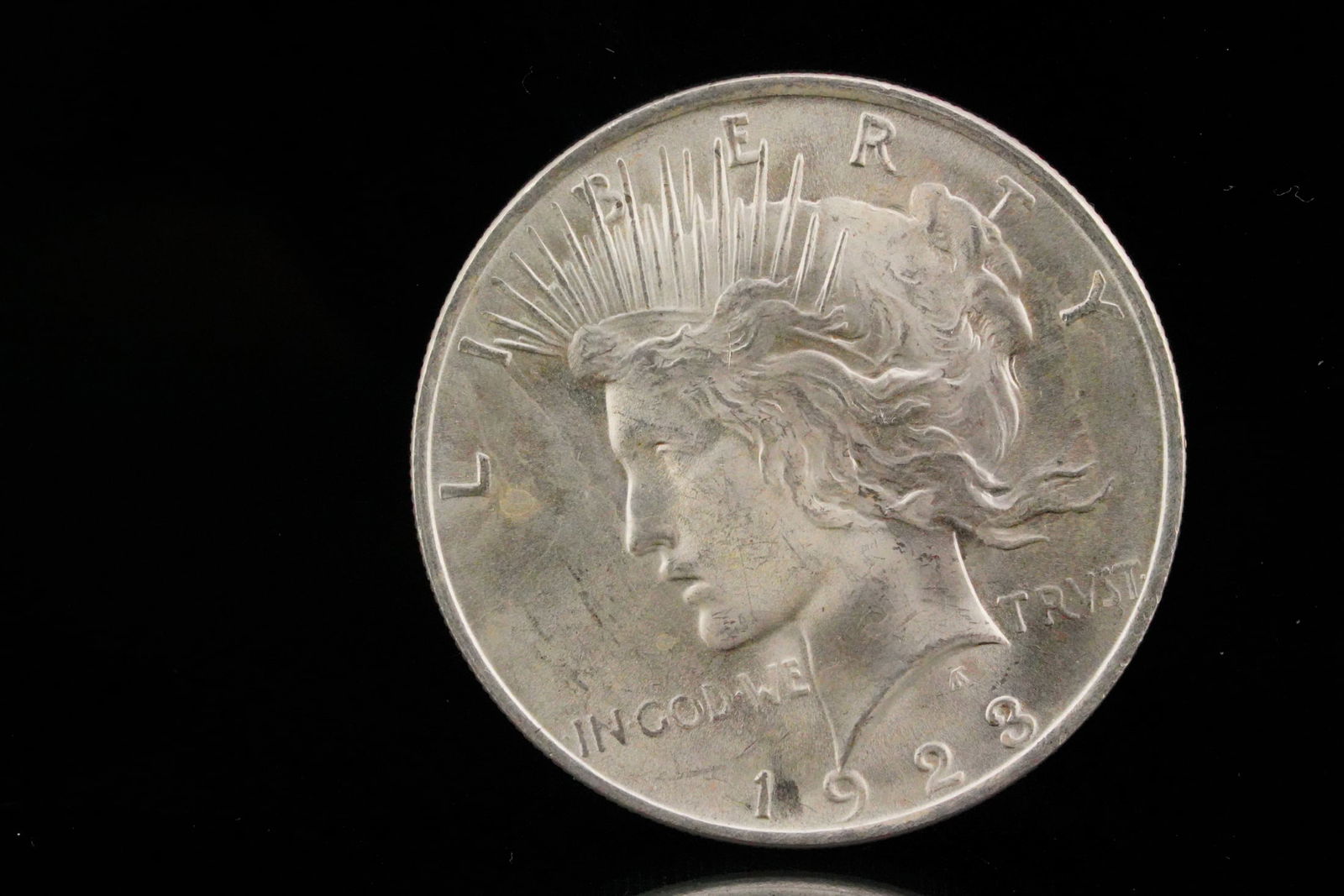 1923 Silver Peace Dollar: 1923 Silver Peace Dollar - Offered here is a 1923 Peace Dollar, struck at the Philadelphia Mint (no mint mark). It is part of the iconic Peace Dollar series (1921-1935) designed by Anthony de Francisc