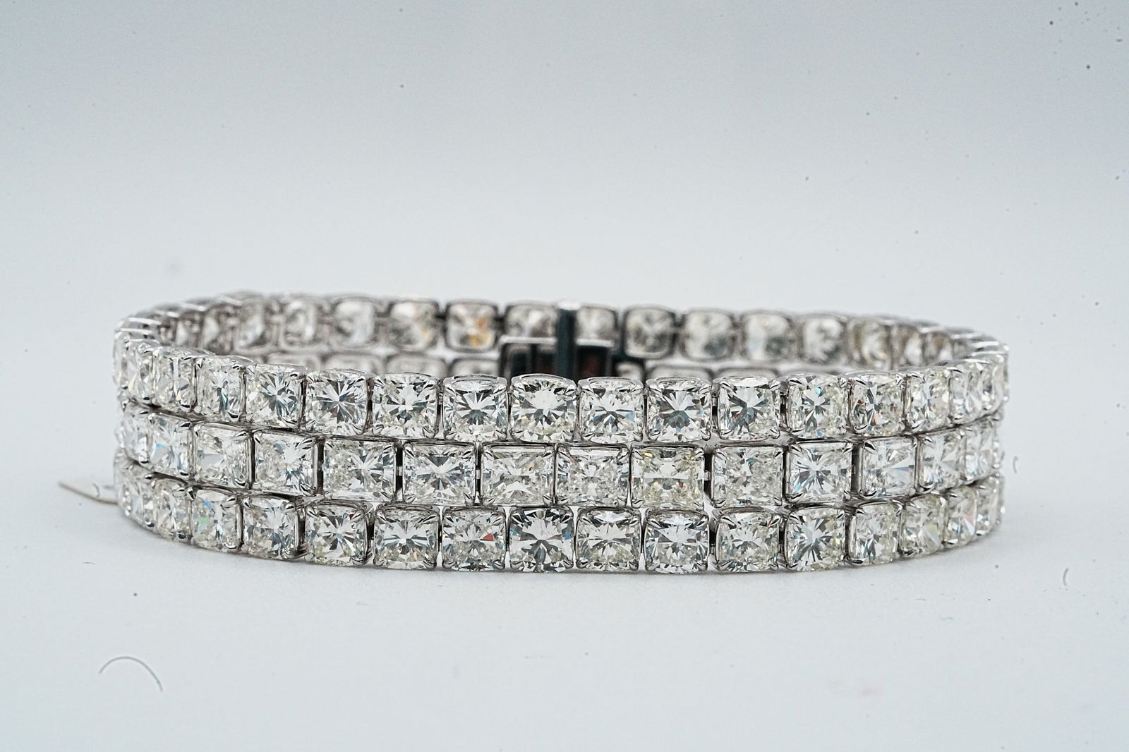 53.30ctw Cushion Cut Diamond and 18K White Gold Bracelet: 53.30ctw VS2-SI1/G-H Cushion Cut Diamond and 18K White Gold 7" Bracelet - This item will come with a $446,000 insurance valuation report in the winning bidder's name by a graduate appraiser. An impres