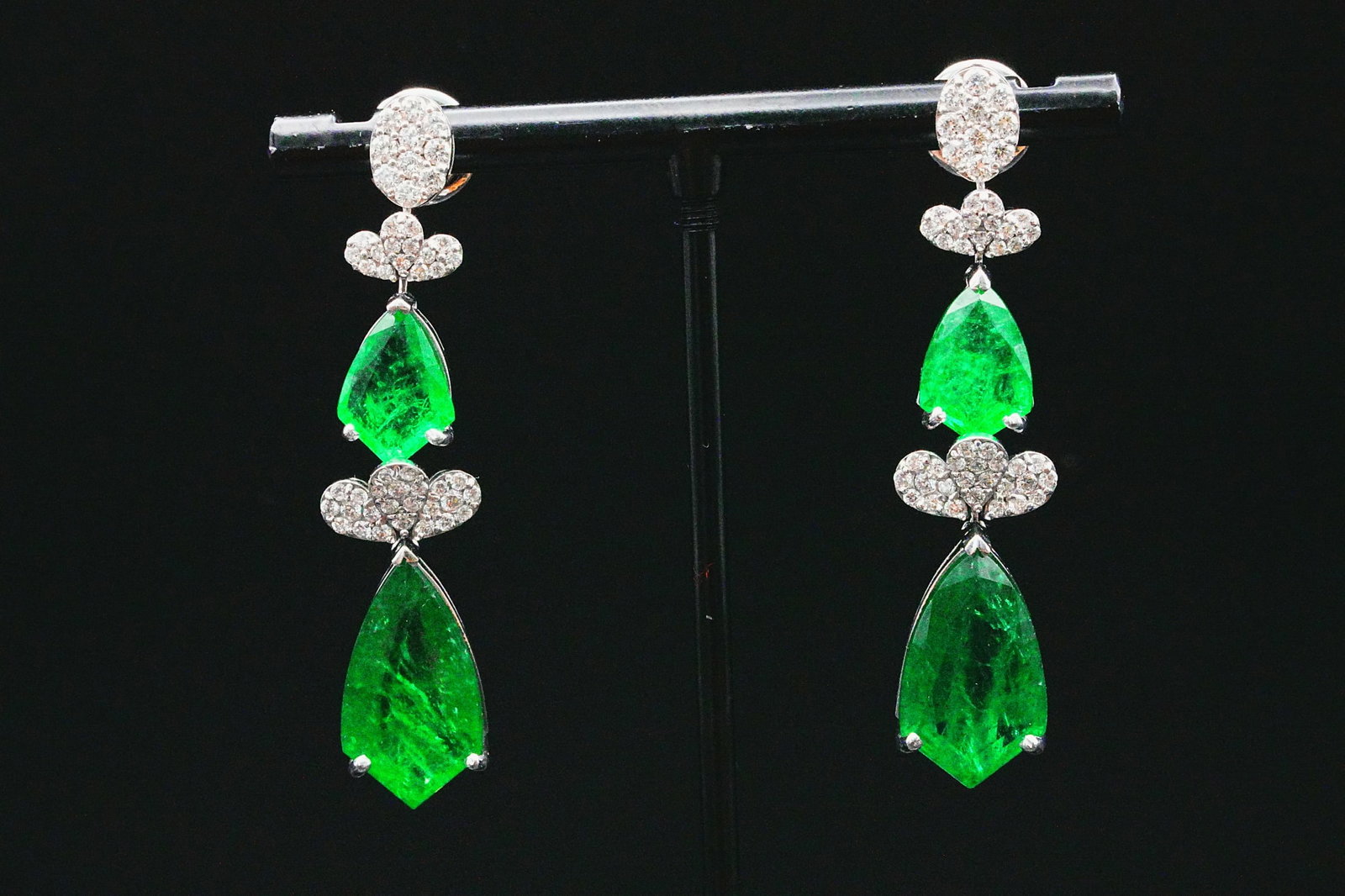 17.60ctw Emerald, 1.20ctw Diamond and 18K Earrings: 17.60ctw Emerald, 1.20ctw VS2-SI1/G-H Diamond and 18K White Gold 1.5" Drop Earrings - This item will come with a $74,000 insurance valuation report in the winning bidder's name by a graduate appraiser