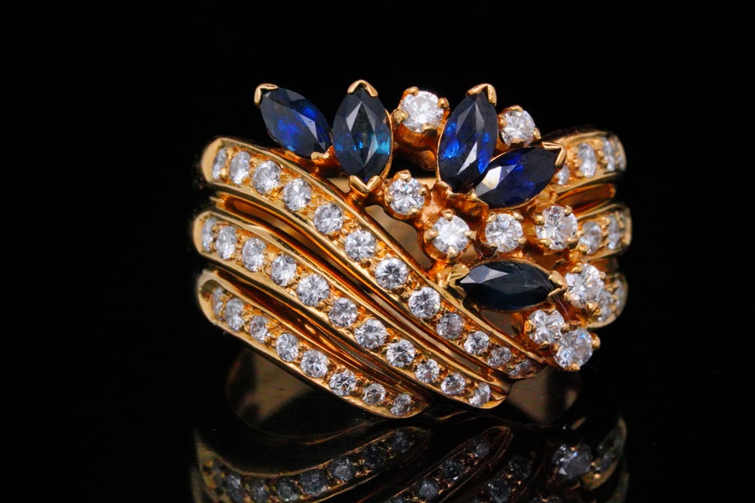 1.30ctw Diamond, 0.80ctw Blue Sapphire and 18K Ring: Italian 1.30ctw SI1-SI2/G-H Diamond, 0.80ctw Blue Sapphire and 18K Yellow Gold Ring - This striking 18K yellow gold ring features an elegant combination of marquise-cut blue sapphires and round brilli