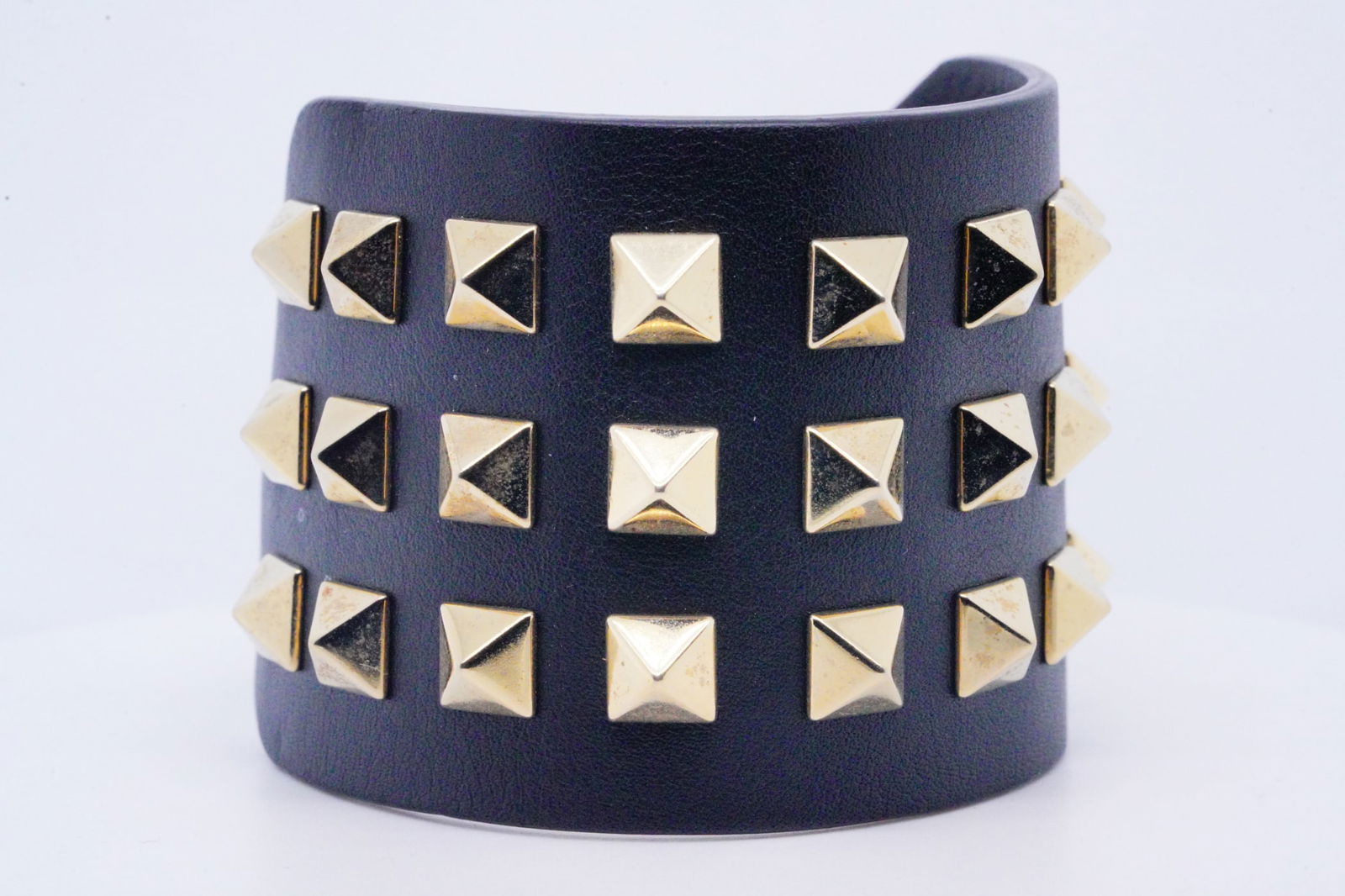 Valentino Garavani Leather 3-Row Rockstud Bracelet: Valentino Garavani Black Leather 3-Row Gold Rockstud Bracelet - The Valentino Garavani Black Leather 3-Row Gold Rockstud Bracelet is a statement piece that exudes modern elegance and bold style. Desig