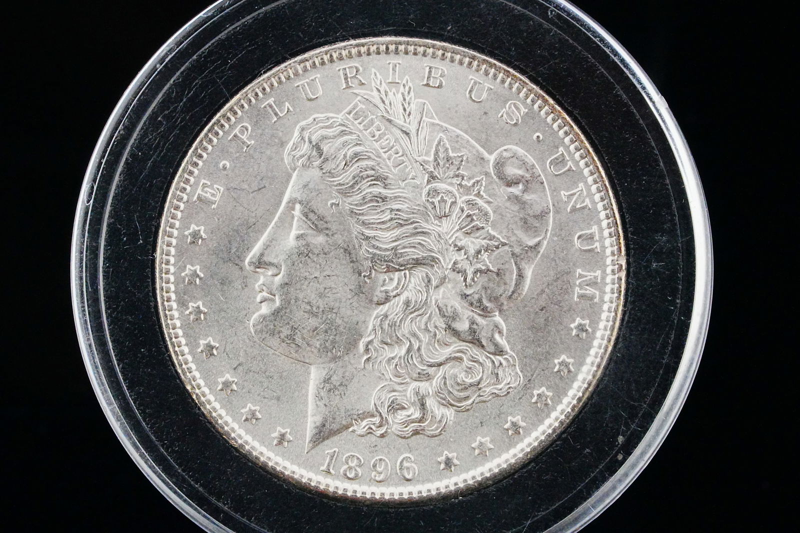 1898-P Morgan Silver Dollar AU Solid 90% Silver: 1898-P Morgan Silver Dollar AU in Capsule - This investment quality coin is made of 90% solid silver. Mintage: 5,884,735 of which 735 were proof coins. This is a great investment coin. AUCTION NOTE: T
