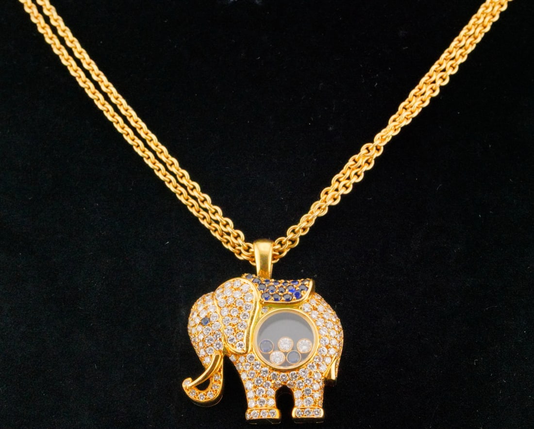 Chopard 2.15ctw Diamond, Sapphire and 18K Necklace: Chopard Happy Diamonds 2.15ctw VS1-VS2/F-G Diamond, 0.60ctw Blue Sapphire and 18K Yellow Gold Elephant Pendant Necklace - This item will come with a $24,000 insurance valuation report in the winning b