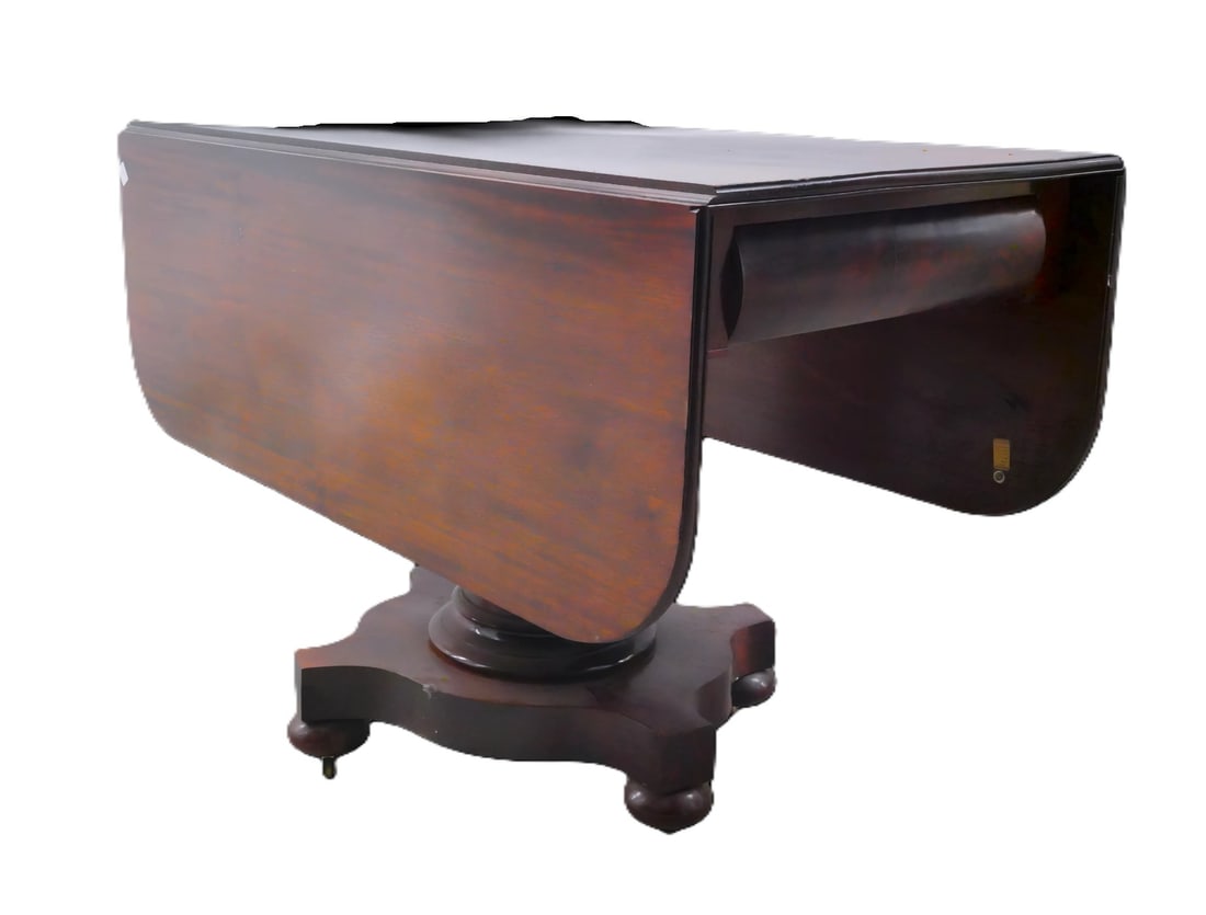 Antique Mahogany Drop-Leaf Pedestal Table: Antique Mahogany Drop-Leaf Pedestal Table - A handsome antique mahogany drop-leaf table. This finely crafted piece features a rectangular top with twin hinged drop leaves, resting on a solid pedestal
