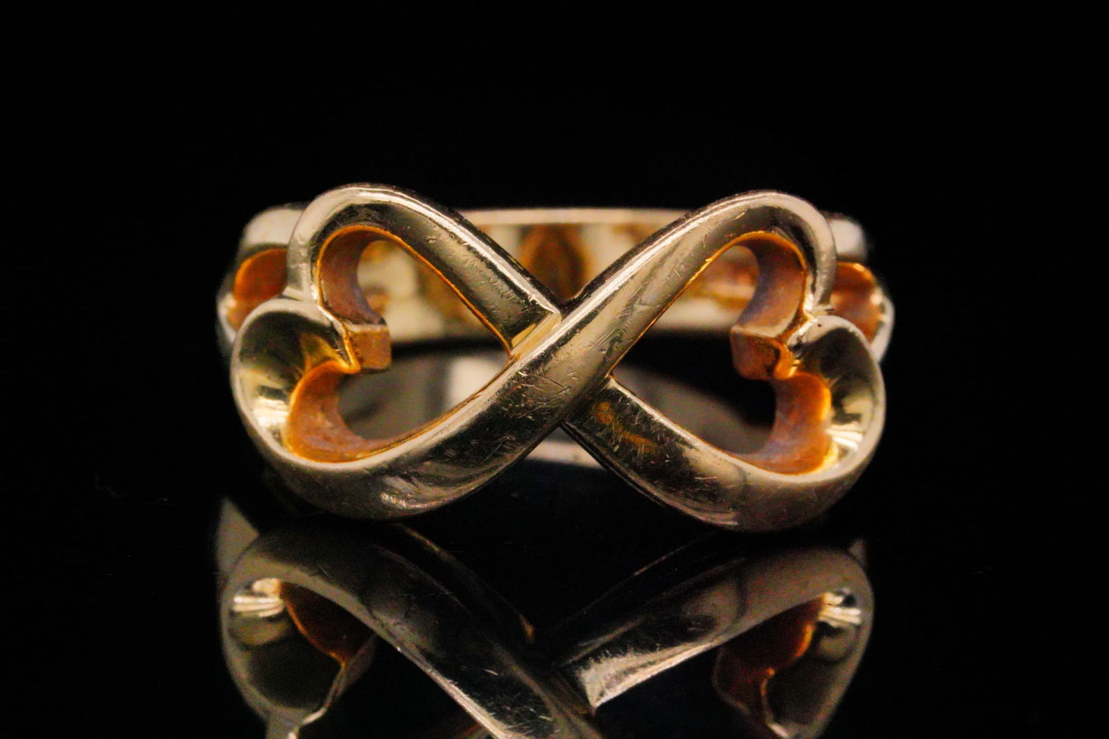 Tiffany & Co. Paloma Picasso 18K Double Heart Ring: Tiffany & Co. Paloma Picasso 18K Yellow Gold Double Heart Infinity Ring - Crafted in rich 18K yellow gold, this elegant Paloma Picasso design features two interlocking heart motifs joined in an infini