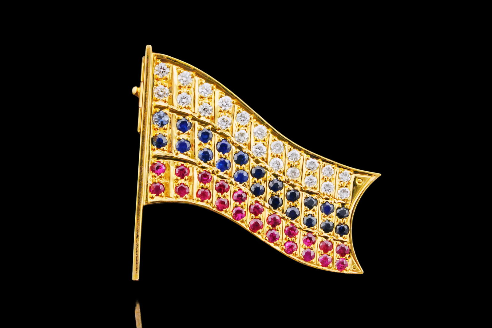 1.50ctw Diamond, Blue Sapphire and Ruby 18K Flag Brooch: 1.50ctw Diamond, Blue Sapphire and Ruby 18K Yellow Gold Flag Brooch - This brooch is crafted in 18k yellow gold and features a flag motif embellished with approximately 1.50ctw fiery white diamonds, b