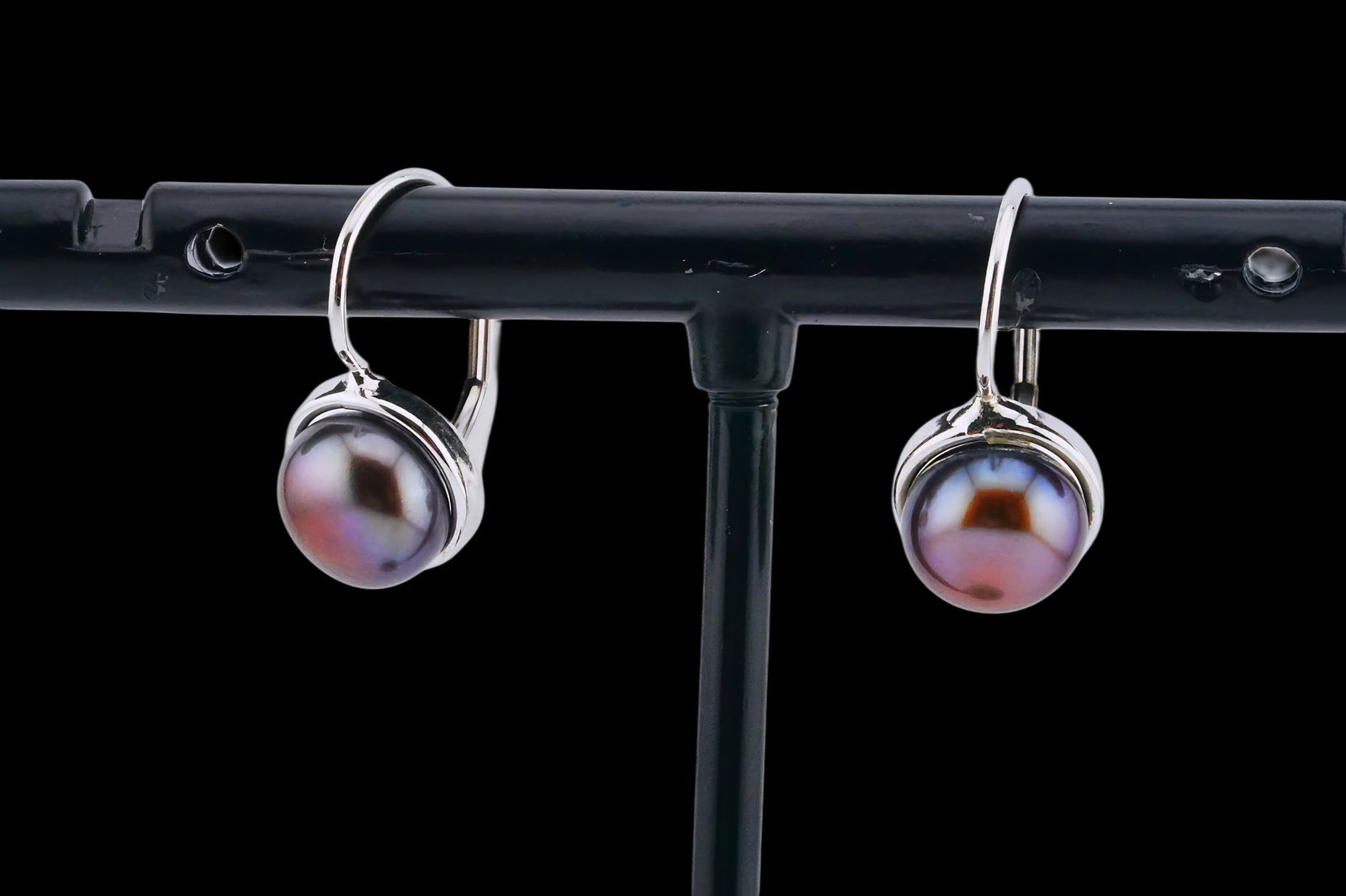 7mm Black Mabe Pearl and 14K White Gold Earrings: 7mm Black Mabe Pearl and 14K White Gold 0.60" Earrings - Elegant and understated, these earrings are crafted in 14K white gold with a graceful wire hook design. Each earring suspends a lustrous 7mm bl