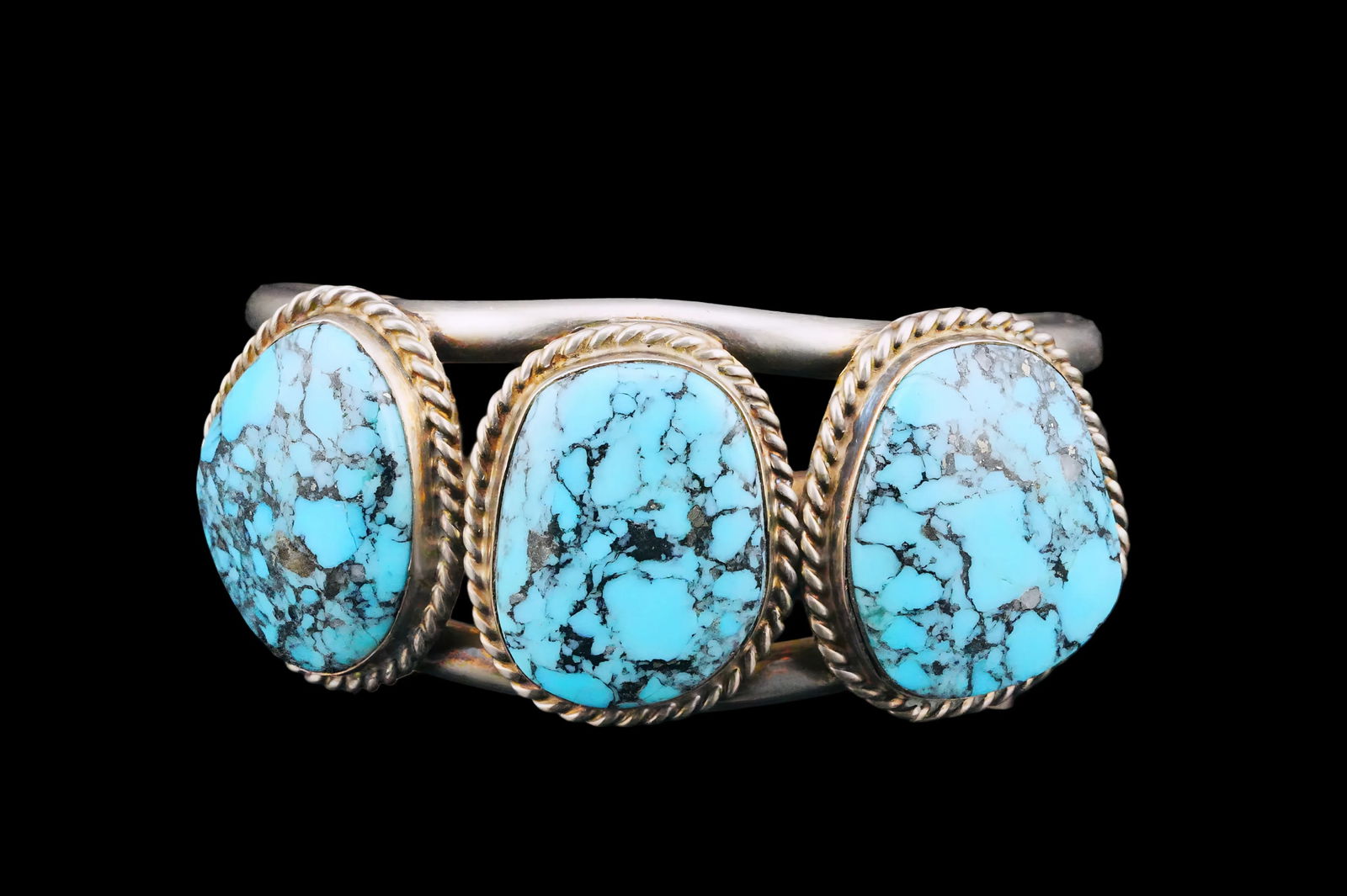 23mm Turquoise and Sterling Silver Cuff Bracelet: Native American 23mm Turquoise and Sterling Silver Cuff Bracelet - Classic design featuring three turquoise cabochons set across the top, each in a bezel setting with rope twist edges. The stones disp