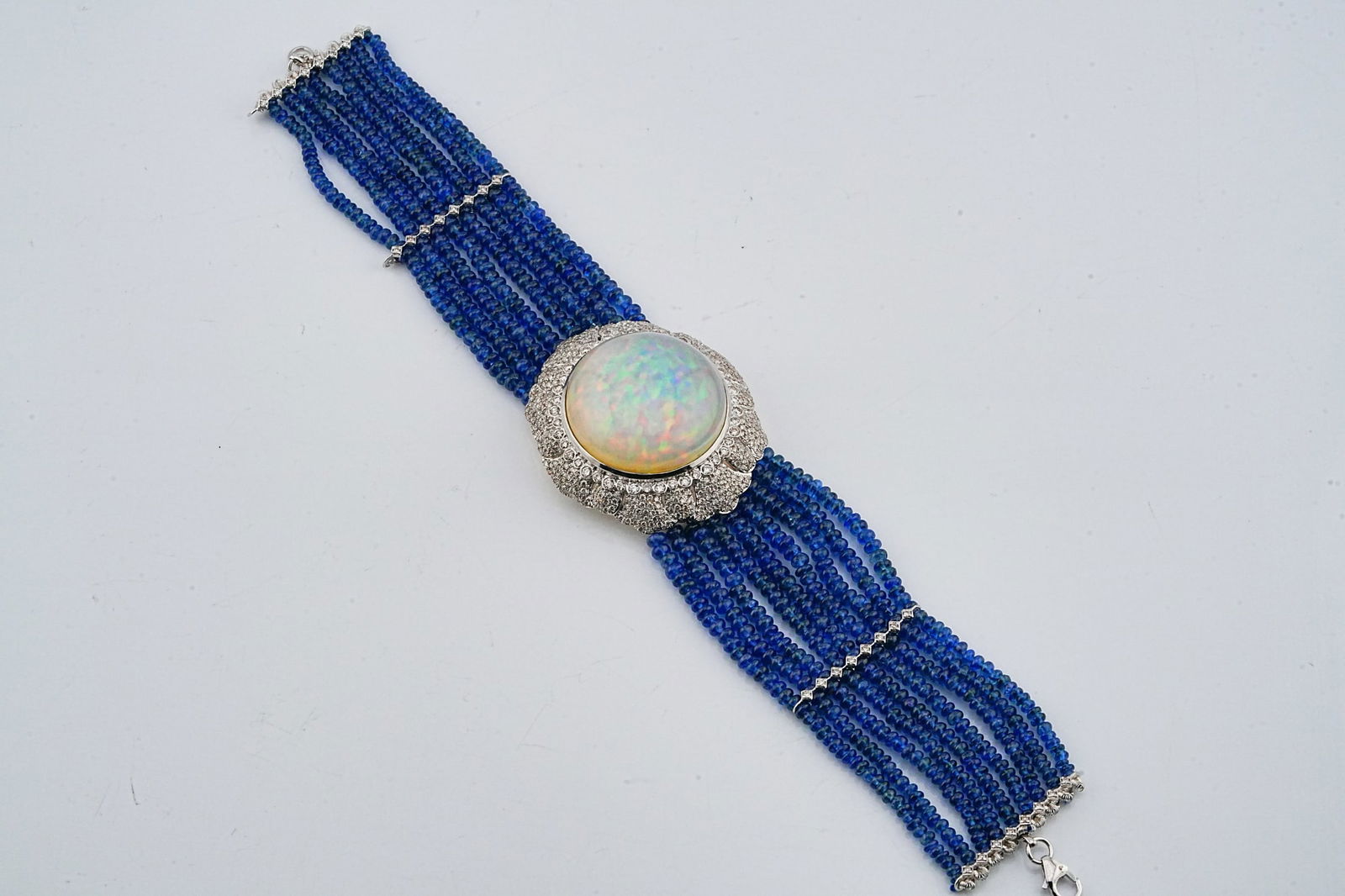 112.85ctw Sapphire, 31.90ct Opal, 3.00ctw Diamond Bracelet: 112.85ctw Blue Sapphire Bead, 31.90ct Opal, 3.00ctw VS1-SI2/G-H Diamond and 18K White Gold 8" Multi-Strand Bracelet - This item will come with a $37,000 insurance valuation report in the winning bidde