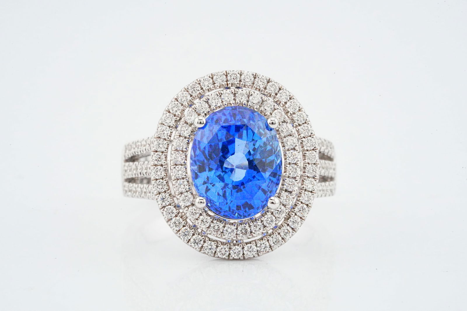 5.00ct Blue Sapphire, 0.75ctw Diamond and 18K Ring: 5.00ct Blue Sapphire, 0.75ctw Diamond and 18K White Gold Ring - This item will come with a $35,000 insurance valuation report in the winning bidder's name. A striking and elegant ring centered by an a