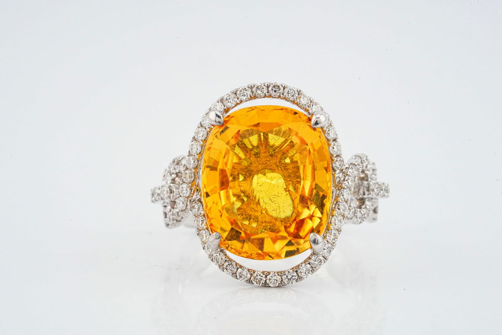 10.85ct Yellow Sapphire, 0.90ctw Diamond and 18K Ring: 10.85ct Yellow Sapphire, 0.90ctw Diamond and 18K White Gold Ring - This item will come with a $40,000 insurance valuation report in the winning bidder's name. An extraordinary high jewelry ring center