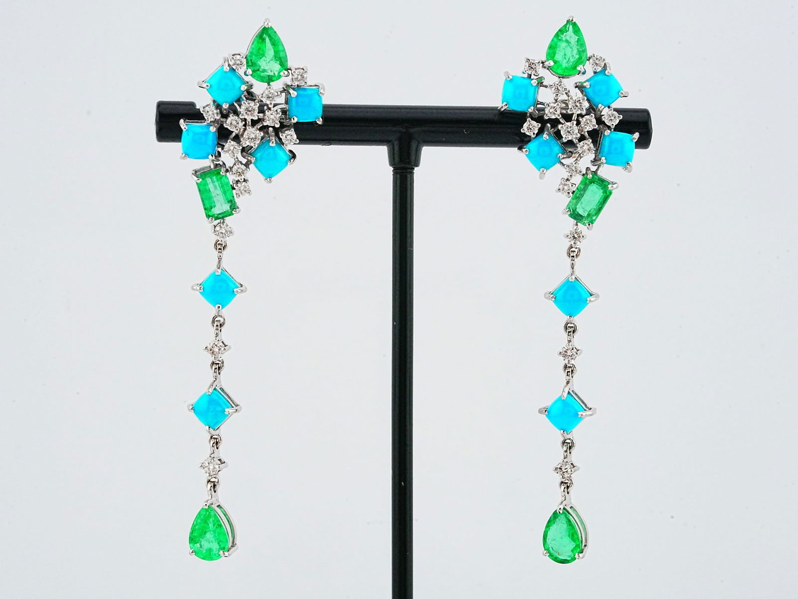 3.90ctw Turquoise, 3.30ctw Emerald, Diamond, 18K Earrings: 3.90ctw Turquoise, 3.30ctw Emerald, 0.75ctw Diamond and 18K White Gold 2.5" Dangle Earrings - This item will come with a $17,000 insurance valuation report in the winning bidder's name. These earrings