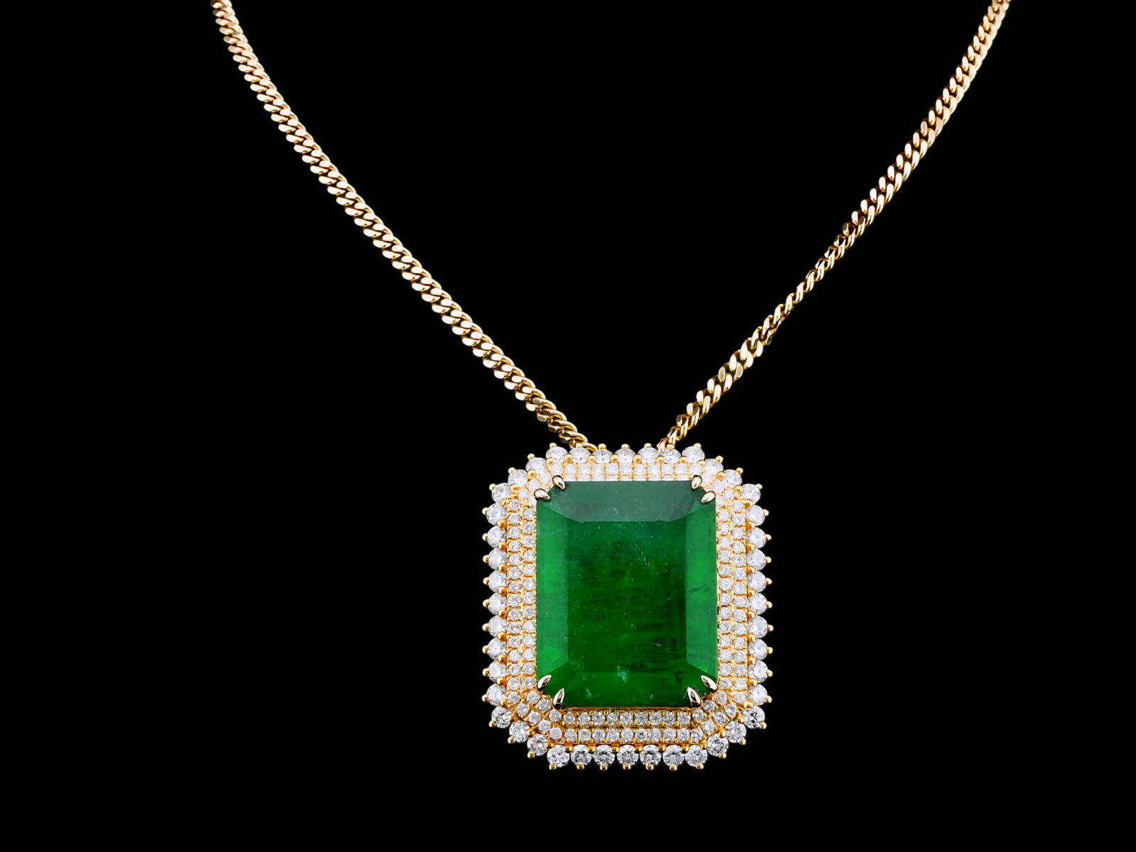 40.25ct Emerald, 5.00ctw Diamond, 18K Pendant/14K Chain: 40.25ct Emerald, 5.00ctw VS1-SI1/G-J Diamond and 18K Yellow Gold 1.5" Pendant on 14K Gold 22" Chain - THIS ITEM WILL COME WITH A $168,000 INSURANCE VALUATION REPORT IN THE WINNING BIDDER'S NAME. This