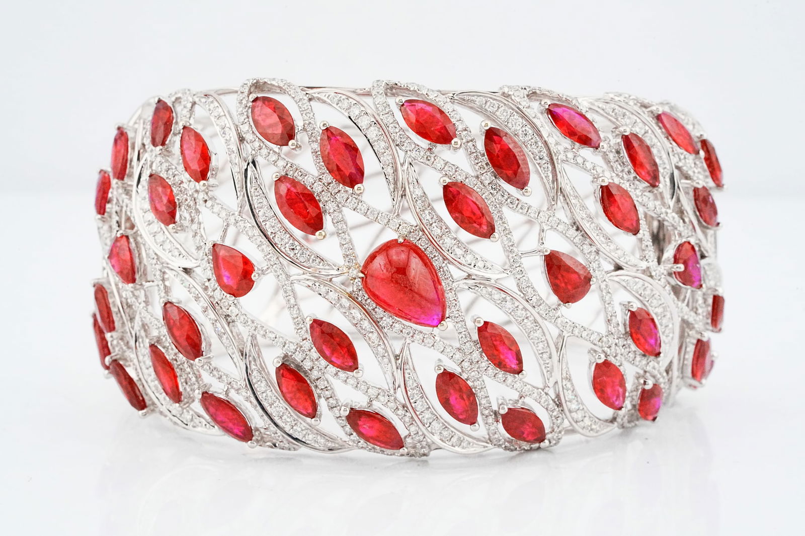 29.00ctw Ruby, 6.20ctw Diamond and 18K Bangle: 29.00ctw Ruby, 6.20ctw VS1-VS2/G-H Diamond and 18K White Gold 1.75" Wide Bangle Bracelet - This item will come with a $93,000 insurance valuation report in the winning bidder's name. An extraordinary