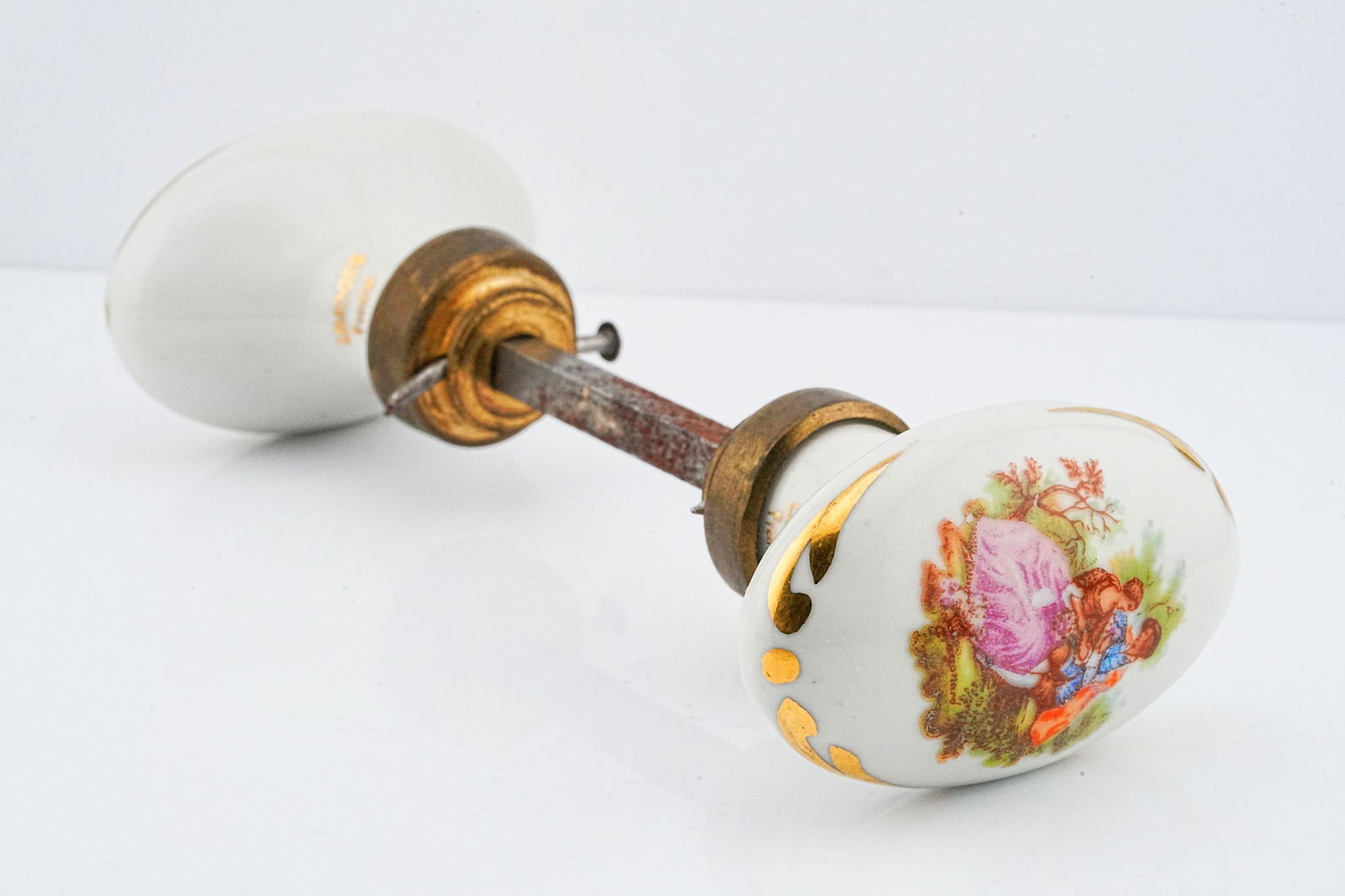 Antique Limoges Hand-Painted Porcelain Door Knob Set: Antique Limoges France Hand-Painted Porcelain Door Knob Set with Romantic Figural Scene - A charming antique door knob set crafted from fine Limoges porcelain, each knob beautifully decorated with a h