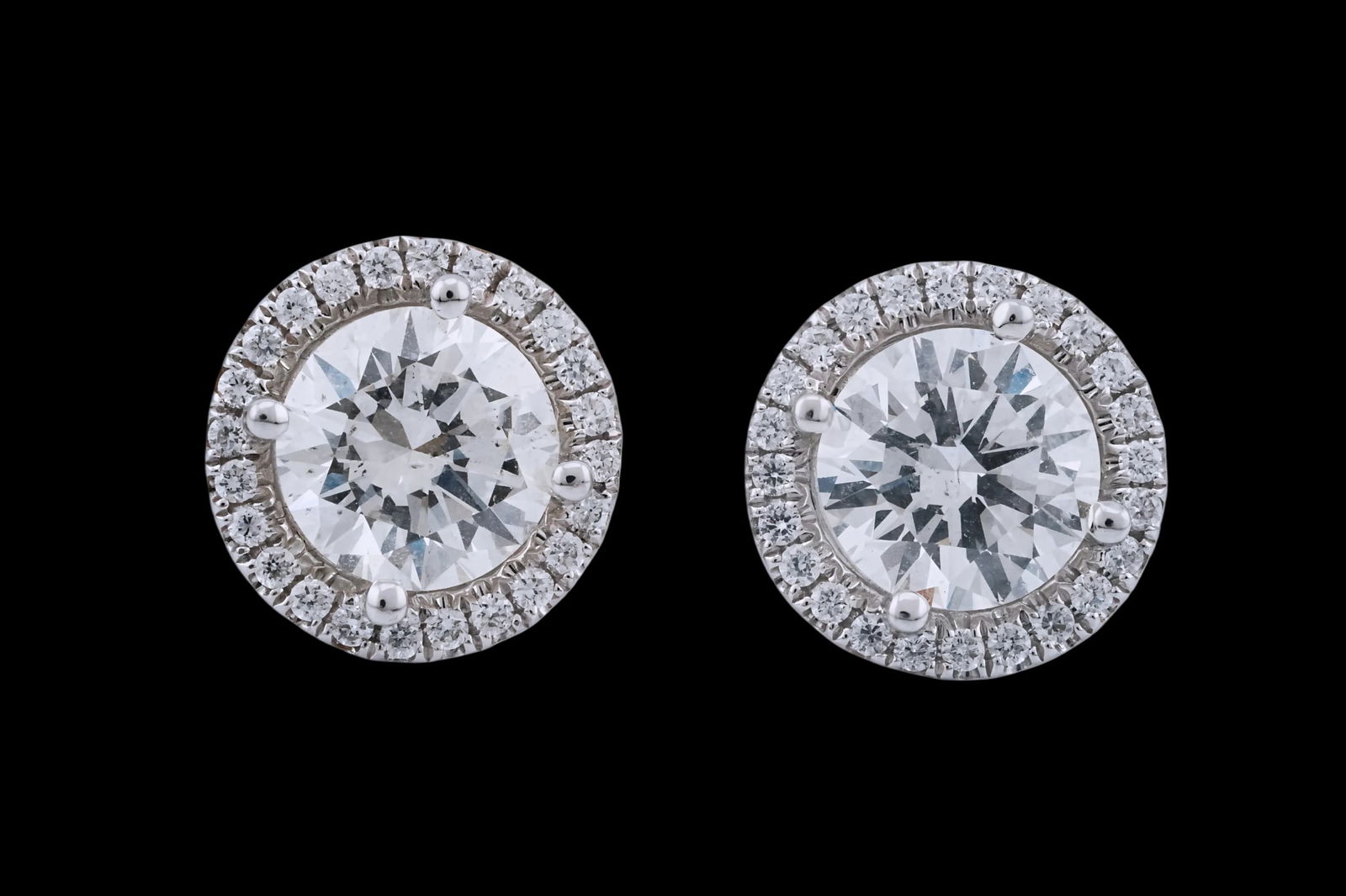 4.01ctw SI1/H Diamond and 18K White Gold Earrings: 4.01ctw SI1/H Diamond, 1.10ctw VS/H Diamond and 18K White Gold 0.50" Stud Earrings - This item will come with a $143,000 insurance valuation report in the winning bidder's name by a graduate