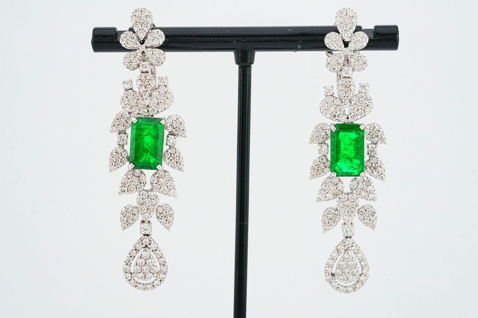 5.00ctw Emerald, 3.40ctw Diamond and 18K Earrings: 5.00ctw Emerald, 3.40ctw VS2-SI1/G-H Diamond and 18K White Gold 2.25" Earrings - This item will come with a $26,000 insurance valuation report in the winning bidder's name. Each earring is centered