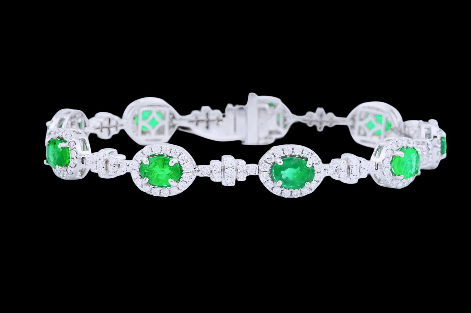 6.90ctw Emerald, 2.50ctw Diamond and 18K Bracelet: 6.90ctw Emerald, 2.50ctw VS1-SI1/F-H Diamond and 18K White Gold 7.5" Bracelet - This item will come with a $44,000 insurance valuation report in the winning bidder's name by a graduate appraiser.