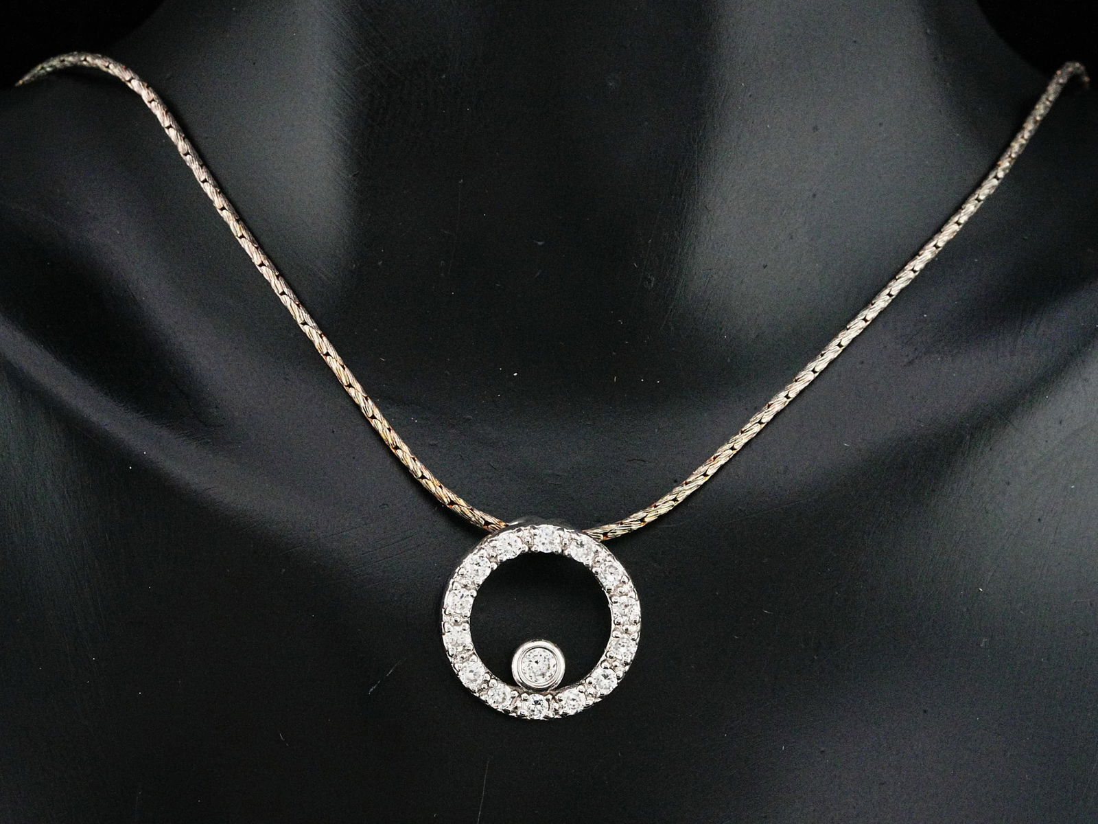 Sterling Silver 16" Crystal Circle Pendant Necklace: Sterling Silver 16" Crystal Circle Pendant Necklace - This necklace is crafted in sterling silver and features a crystal-paved circle pendant hanging on a 16" chain. Weight: 5.7 grams. AUCTION NOTE: