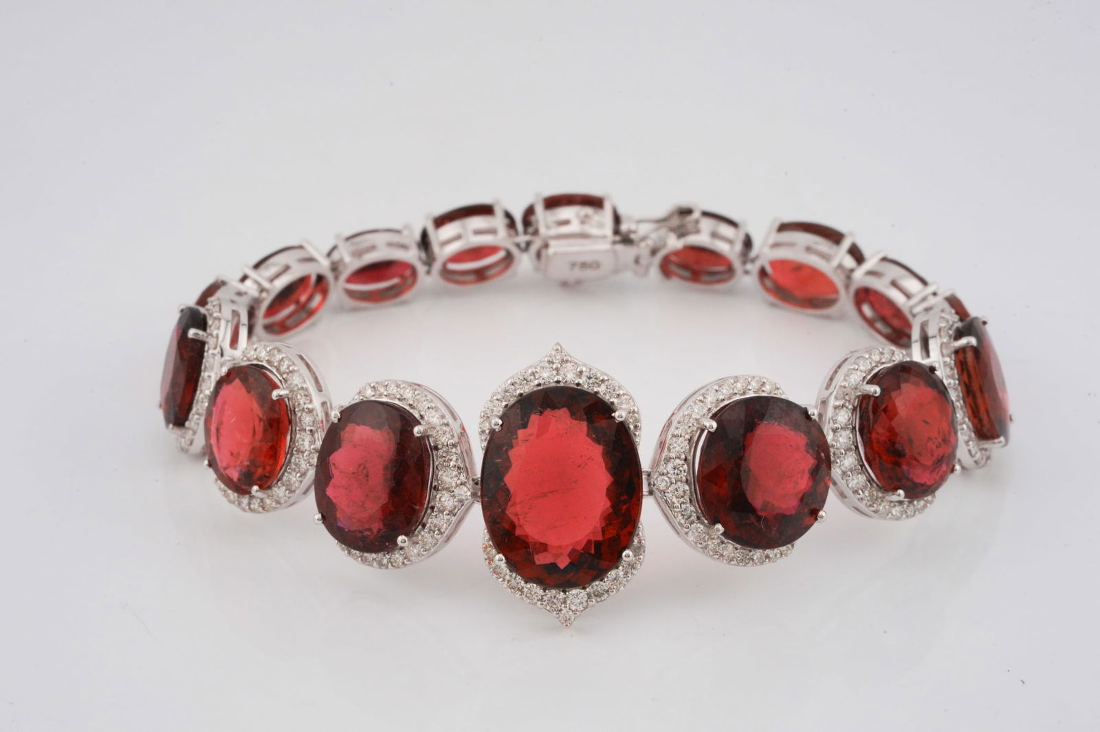 54.40ctw Rubellite, 1.80ctw Diamond and 18K Bracelet: 54.40ctw Rubellite Tourmaline, 1.80ctw VS1-VS2/G-H Diamond and 18K White Gold 7" Bracelet - This item will come with a $31,000 insurance valuation report in the winning bidder's name. An extraordinary