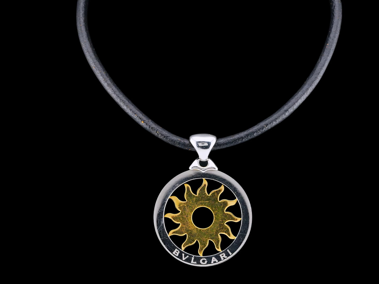 Bvlgari Tondo Sun 18K, Steel and Leather Necklace: Bvlgari Tondo Sun 18K Yellow Gold, Stainless Steel and Black Leather 14.5" Necklace - This iconic Bvlgari Tondo Sun necklace is crafted in a distinctive combination of 18K yellow gold and stainless