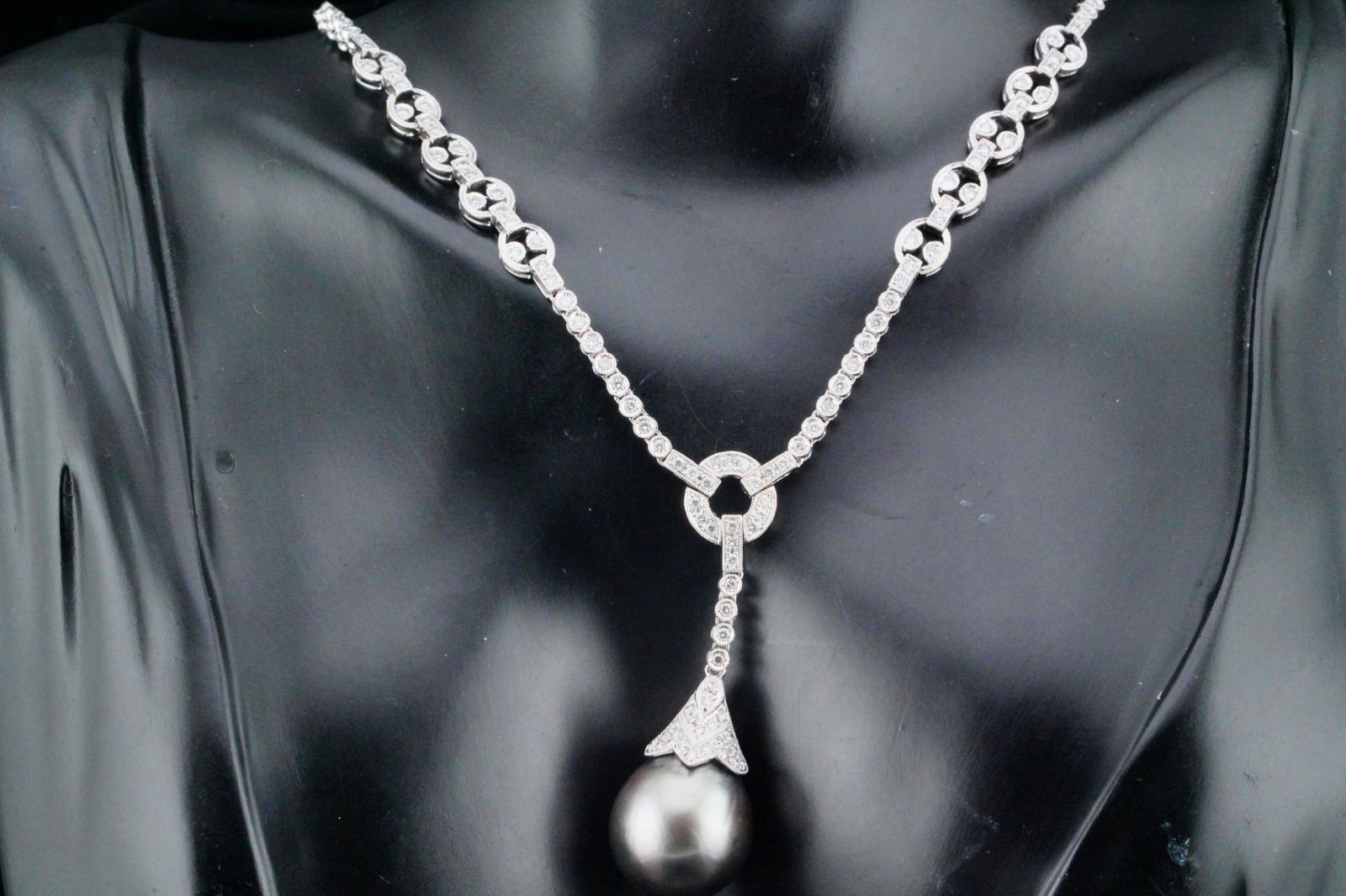 1.50ctw Diamond, 16.5mm Tahitian Pearl, 18K Necklace: 1.50ctw SI1-SI2/G-H Diamond, 16.5mm Tahitian South Sea Pearl and 18K White Gold Necklace - THIS ITEM WILL COME WITH A $15,000 INSURANCE VALUATION REPORT IN THE WINNING BIDDER'S NAME. An exquisite exam