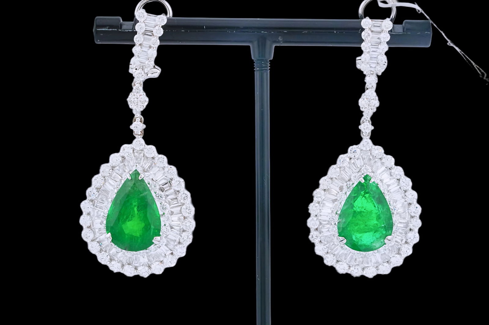 10.08ctw Emerald, 7.00ctw Diamond and 18K Earrings: 10.08ctw Emerald, 7.00ctw VS2-SI1/G-H Diamond and 18K White Gold 2" Drop Earrings - This item will come with a $65,000 insurance valuation report in the winning bidder's name by a graduate appraiser.