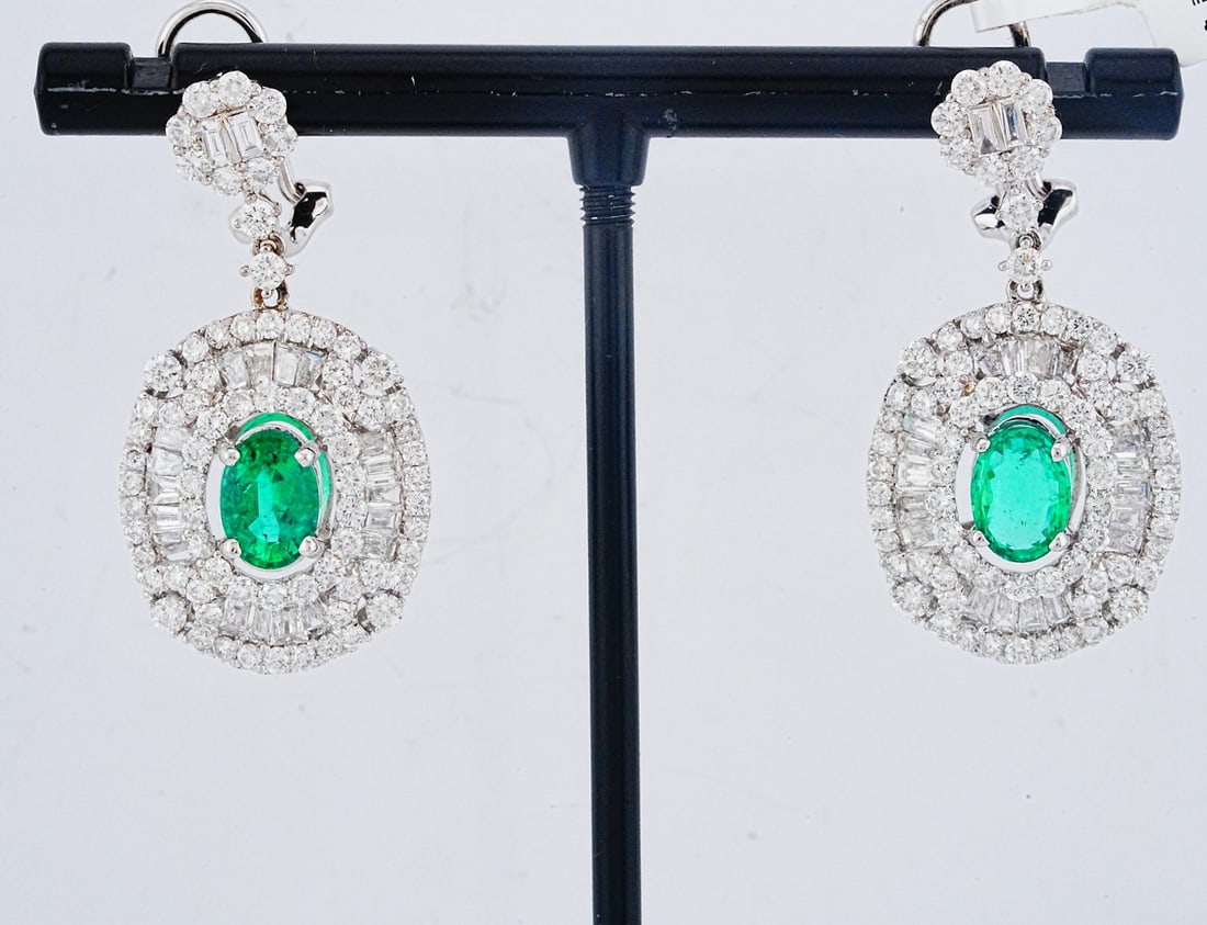 3.45ctw Diamond, 1.76ctw Emerald and 18K Earrings: 3.45ctw VS1-SI1/G-H Diamond, 1.76ctw Emerald and 18K White Gold 1.25" Drop Earrings - This item will come with a $19,500 insurance valuation report in the winning bidder's name by a graduate appraiser