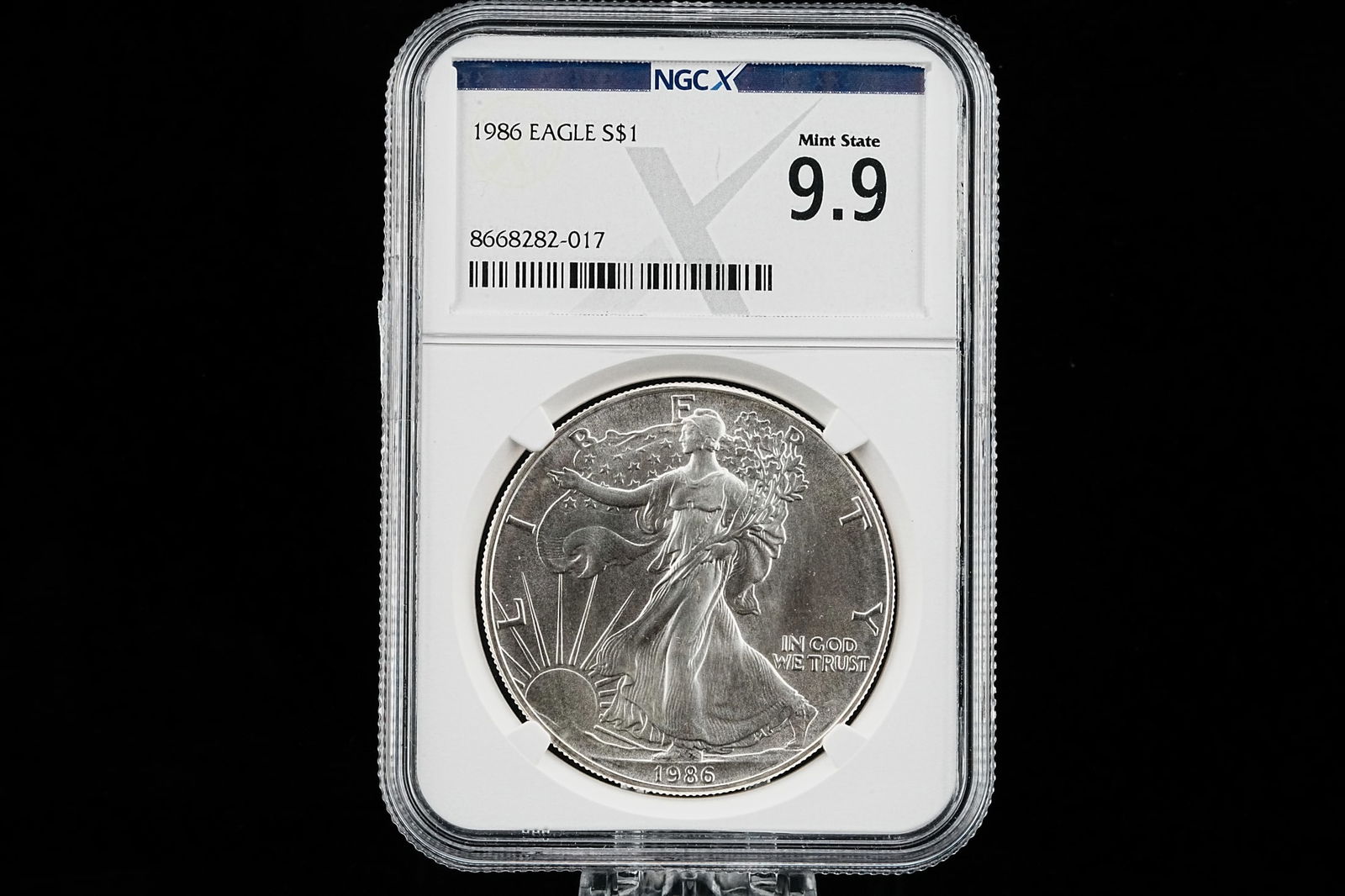 1986 American Silver Eagle NGCX Mint State 9.9: 1986 American Silver Eagle 1 Troy Ounce .999 Fine Silver Coin NGCX Mint State 9.9 First Year of Issue - A superb example from the inaugural year of one of the most iconic bullion coin programs in mode