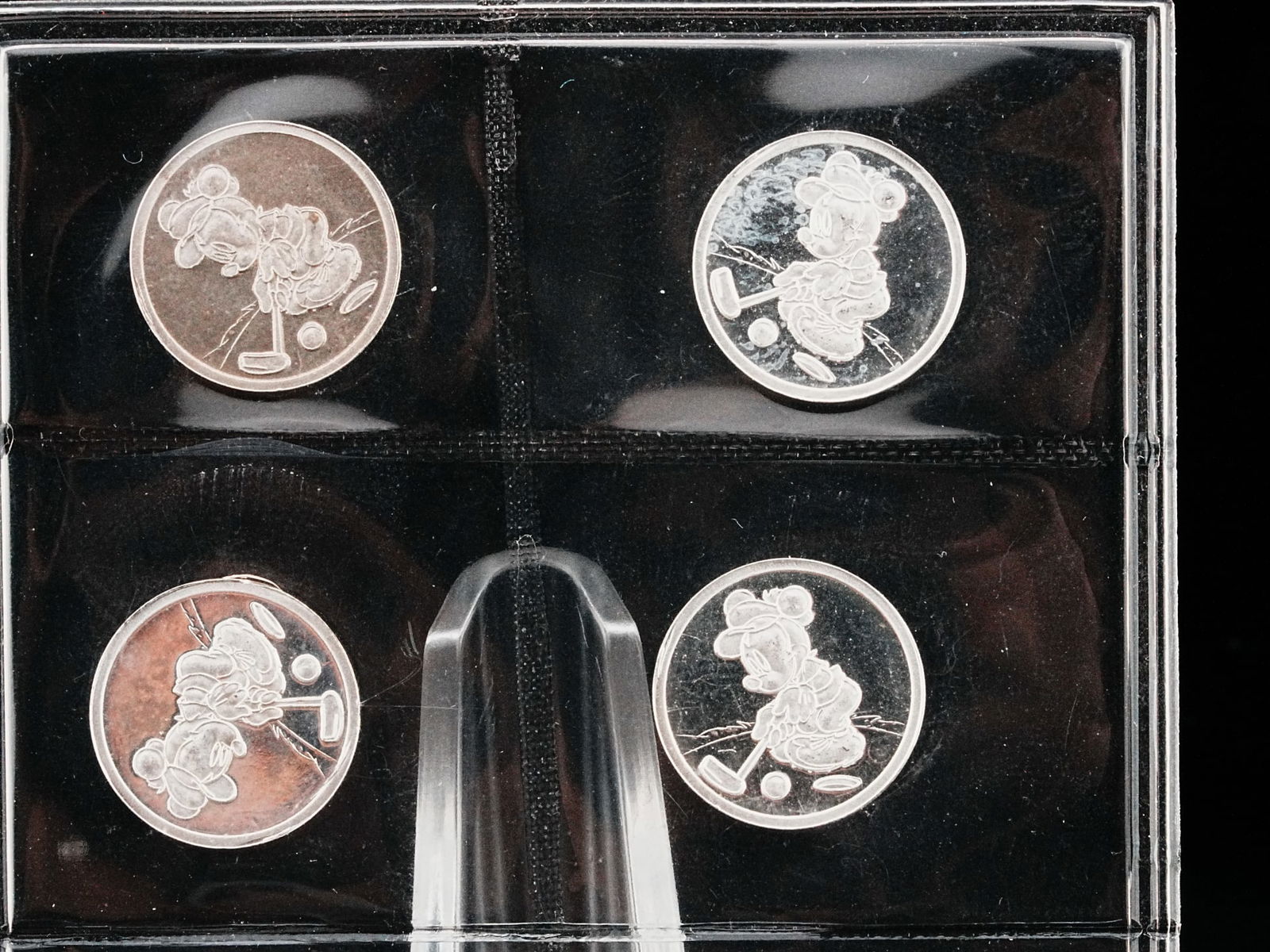 Lot of (4) Mickey Mouse 2 Gram .999 Silver Rounds: Lot of (4) Mickey Mouse Golfing 2 Gram .999 Fine Silver Rounds - A charming lot of four collectible Mickey Mouse themed silver rounds, each struck in .999 fine silver and weighing 2 grams. The rounds