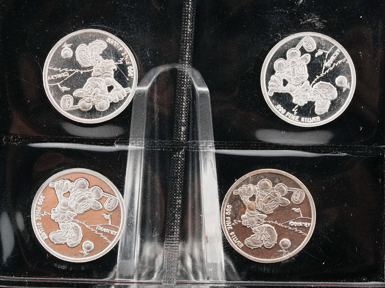 Lot of (4) Mickey Mouse 2 Gram .999 Silver Rounds: Lot of (4) Mickey Mouse Golfing 2 Gram .999 Fine Silver Rounds - A charming lot of four collectible Mickey Mouse themed silver rounds, each struck in .999 fine silver and weighing 2 grams. The rounds