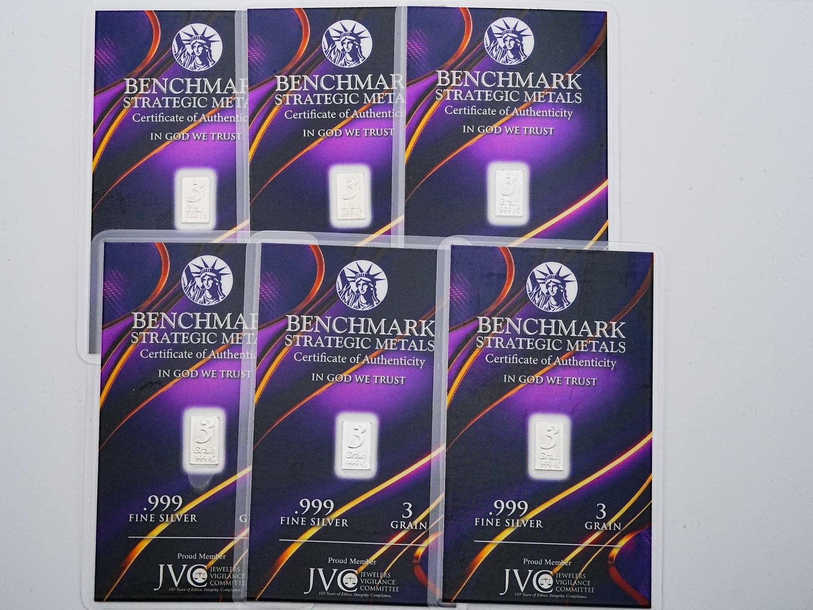 Lot of (6) 3 Grain .999 Fine Silver Bars: Lot of (6) Benchmark Strategic Metals 3 Grain .999 Fine Silver Bars in Sealed Certificates - A collectible lot of six Benchmark Strategic Metals silver bars, each weighing 3 grains and struck in .999