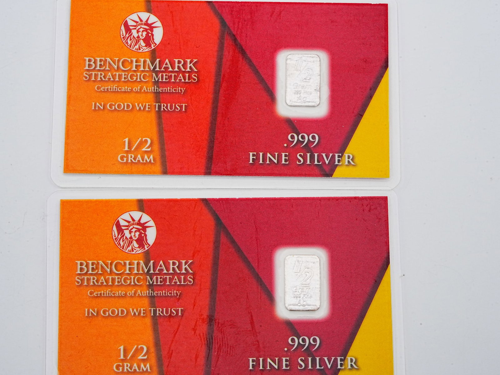 Lot of (2) 1/2 Gram .999 Fine Silver Bars: Lot of (2) Benchmark Strategic Metals 1/2 Gram .999 Fine Silver Bars in Sealed Certificates - A collectible lot of two Benchmark Strategic Metals silver bars, each weighing 1/2 gram and struck in