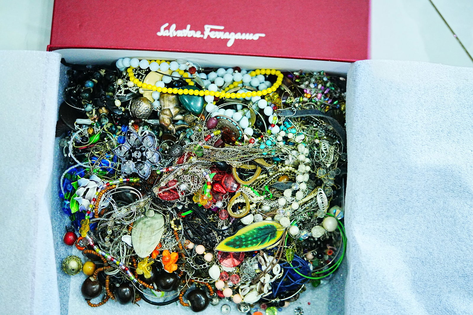 Huge Lot of Unsearched Costume Jewelry (Approx. 7 LB.): Huge Mixed Lot of Unsearched Costume Jewelry (Approx. 7 LB.) in Ferragamo Shoe Box - An expansive and exciting assortment of costume jewelry, this substantial lot weighs approximately 7 pounds and is