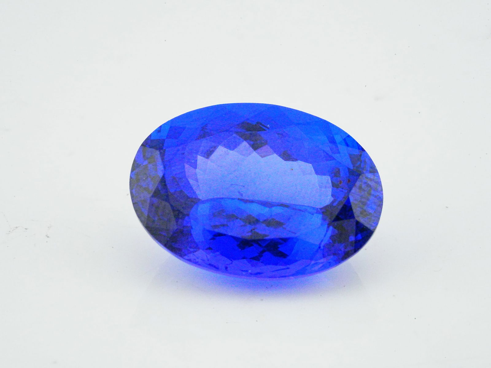 13.00ct Oval-Cut Block D Tanzanite: 13.00ct Oval-Cut Block D Tanzanite - THIS ITEM WILL COME WITH AN $8,000 INSURANCE VALUATION REPORT IN THE WINNING BIDDER'S NAME. An exceptional loose oval-cut tanzanite of impressive 13.00 carats
