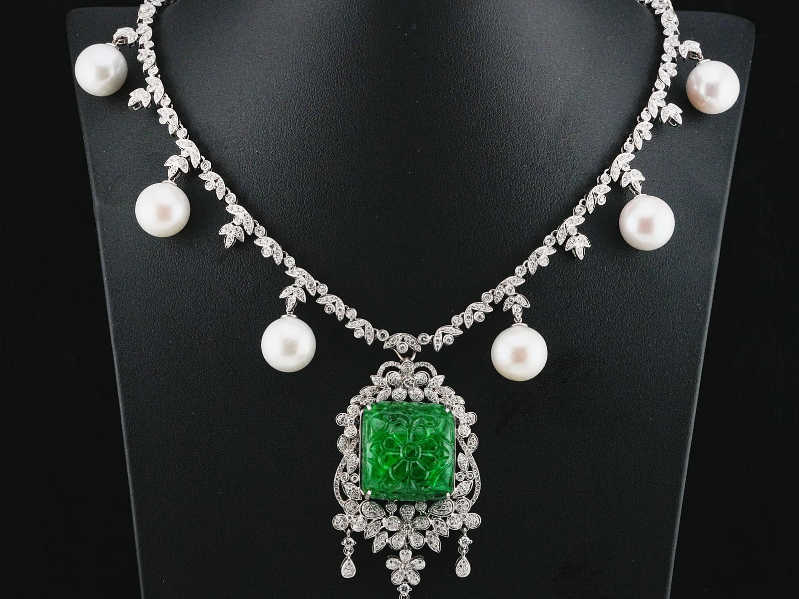 54.50ct Emerald, 9.25ctw Diamond, Pearl, 18K Necklace: 54.50ct Carved Emerald, 9.25ctw VS1-SI1/G-H Diamond, 13.5mm Pearl and 18K White Gold 18" Necklace - THIS ITEM WILL COME WITH A $120,000 INSURANCE VALUATION REPORT. A truly magnificent and artistically