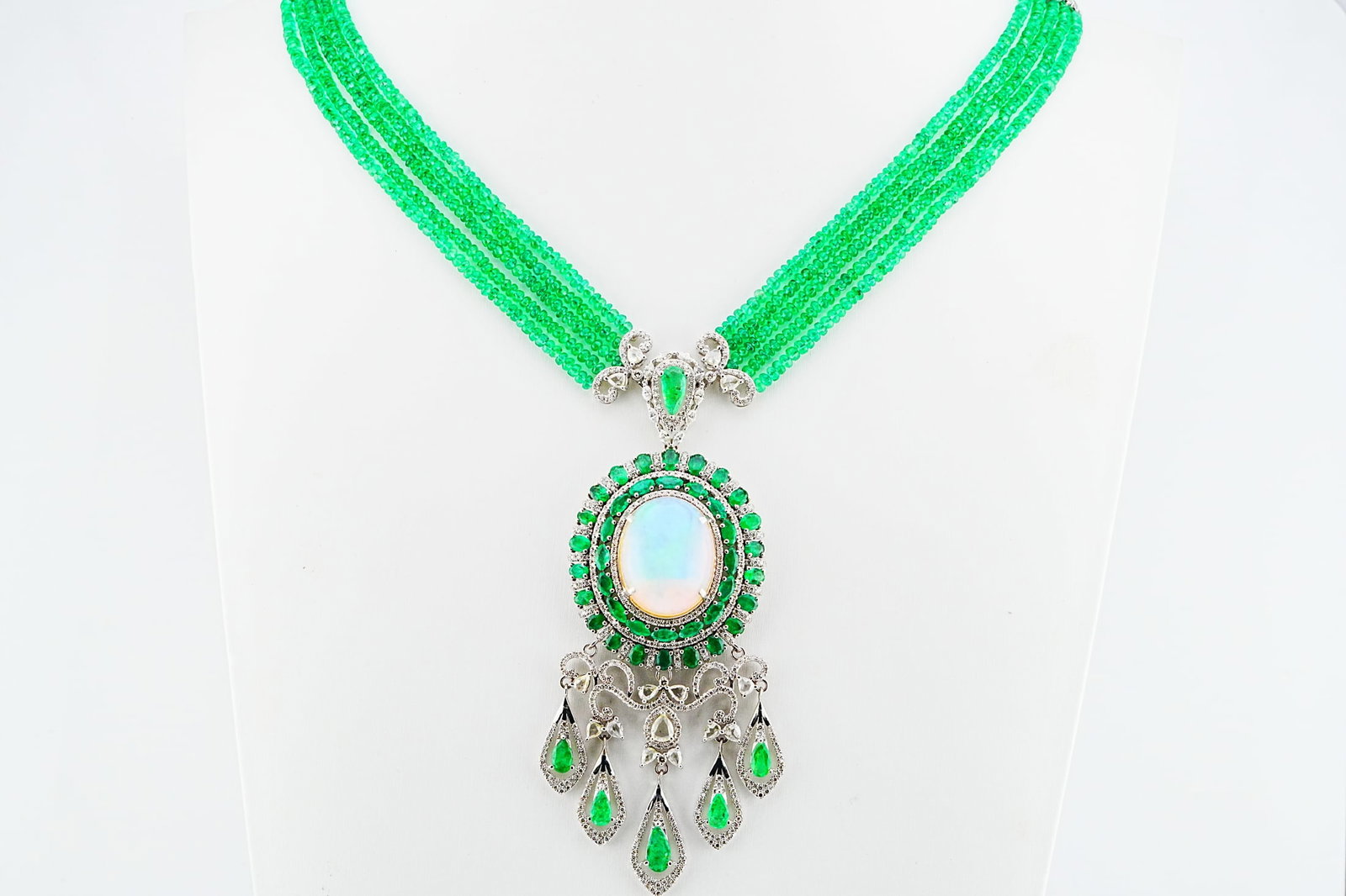 168.60ctw Emerald, 19.70ct Opal, 5.75ctw Diamond Necklace: 168.60ctw Emerald, 19.70ct Opal, 5.75ctw Diamond and 18K White Gold 5-Strand 21" Statement Necklace - THIS ITEM WILL COME WITH A $51,000 INSURANCE VALUATION REPORT. A magnificent and highly important