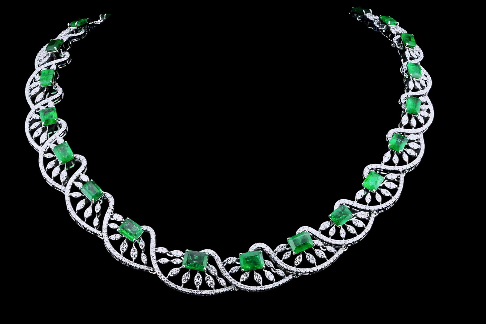 30.75ctw Emerald, 11.50ctw Diamond and 18K Necklace: 30.75ctw Emerald, 11.50ctw VS1-SI1/G-J Diamond and 18K White Gold 16" Cocktail Necklace - THIS ITEM WILL COME WITH A $149,000 INSURANCE VALUATION REPORT. This impressive cocktail necklace is expertly