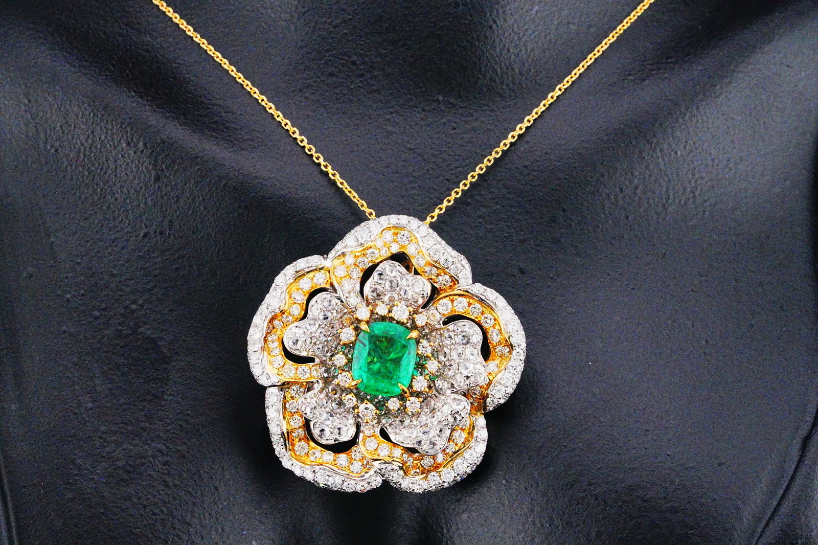 5.50ctw Diamond, 3.00ct Emerald and 18K Necklace: 5.50ctw VS2-SI2/G-J Diamond, 3.00ct Emerald and 18K Yellow/White Gold 18" Flower Pendant Necklace - THIS ITEM WILL COME WITH A $24,500 INSURANCE VALUATION REPORT. A captivating celebration of nature-i