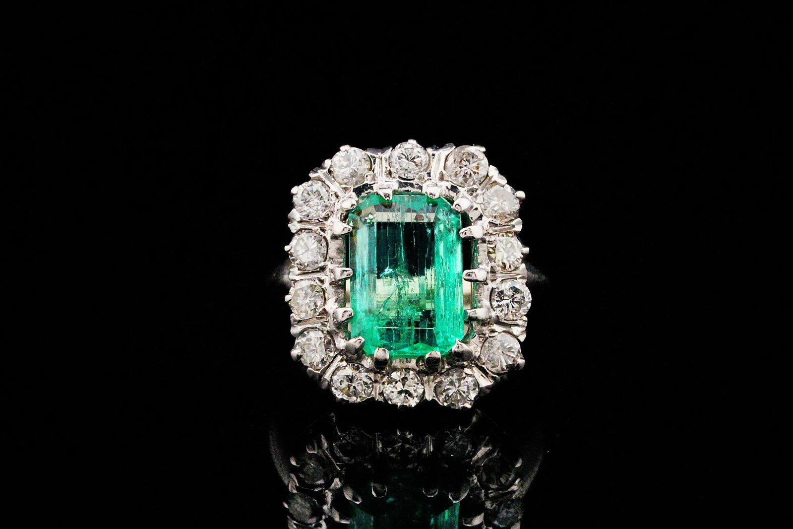 4.00ct Emerald, 1.60ctw Diamond and Platinum Ring: 4.00ct Emerald, 1.60ctw SI1-I1/G-H Diamond and Platinum Vintage Ring - A striking vintage statement piece, this elegant platinum ring showcases a captivating approximately 4.00 carat emerald-cut emera