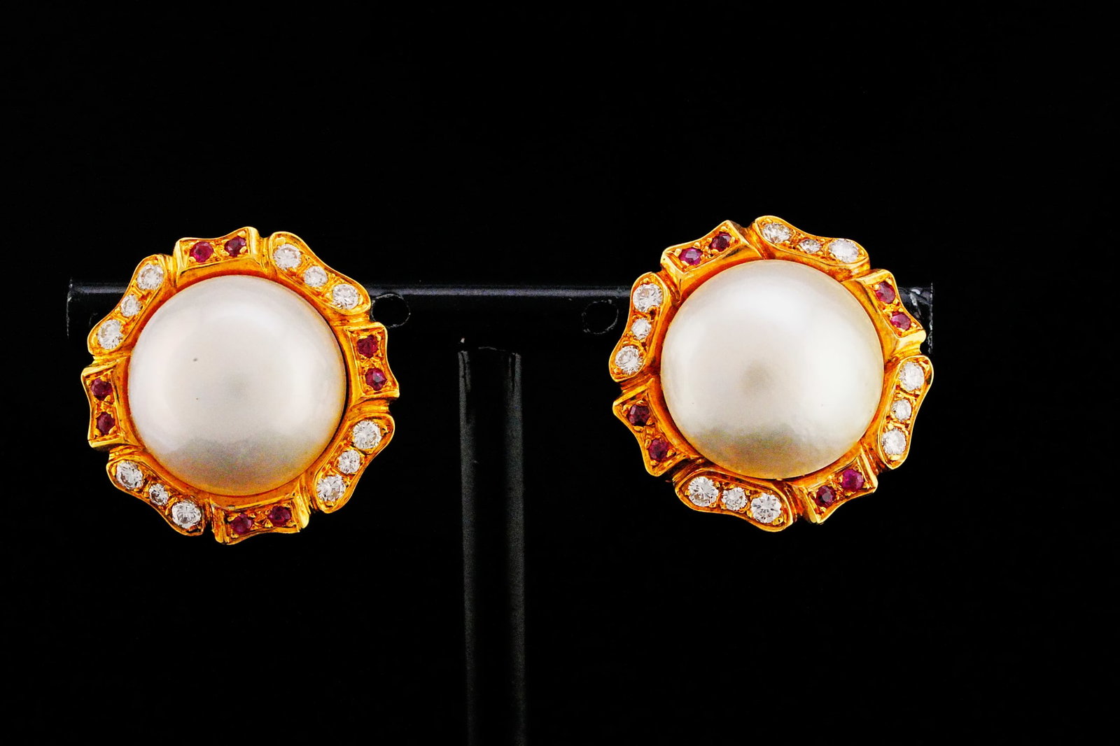 14.5mm Mabe Pearl, Diamond and 18K Earrings W/Rubies: 14.5mm Mabe Pearl, 0.30ctw Diamond and 18K Yellow Gold 0.85" Earrings W/Ruby Accents - Elegant and richly detailed, these vintage-inspired earrings showcase luminous 14.5mm mabe pearls as the striking