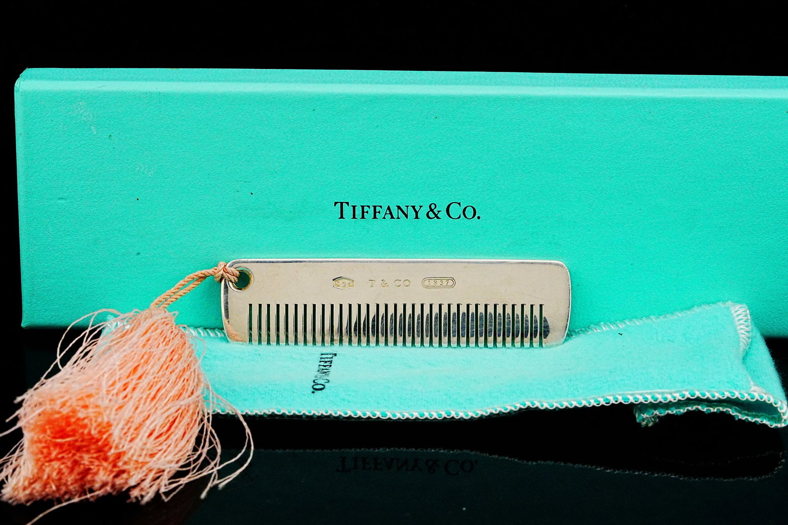Tiffany & Co. Italy Sterling Silver Baby Comb W/Box: Tiffany & Co. Italy Sterling Silver Baby Comb with Pink Tassel W/Pouch and Box - An elegant and timeless keepsake from Tiffany & Co., this sterling silver baby comb is crafted in Italy and exemplifies