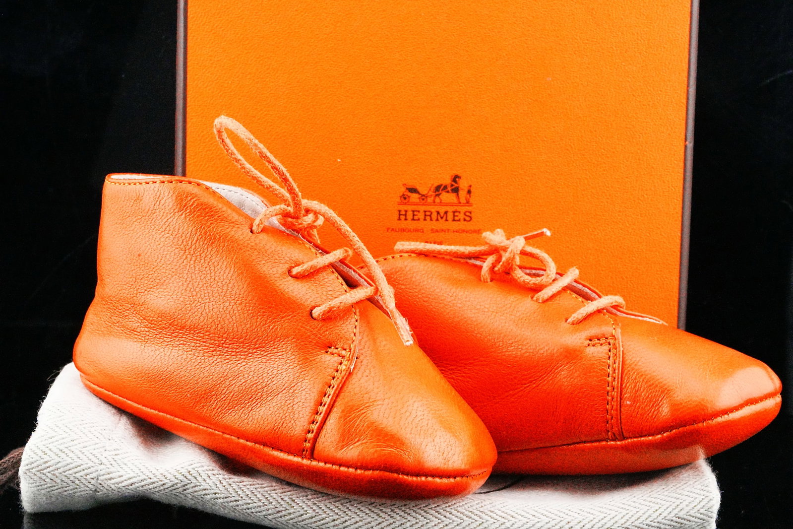 Hermes Baby First Shoes in Orange Leather Unworn W/Box: Hermes Baby First Shoes in Orange Leather Unworn W/Box and Dustbag - A beautifully crafted and highly coveted infant accessory from Hermes, these Baby First Shoes are rendered in supple orange leather