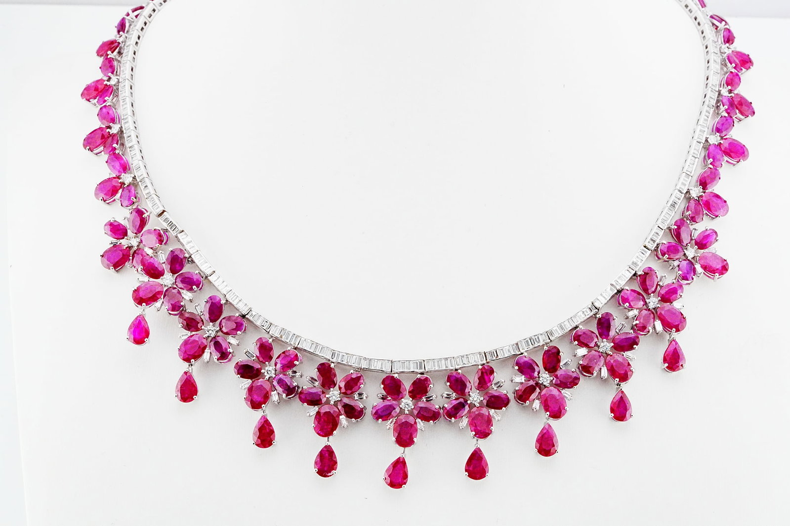 56.75ctw Ruby, 8.80ctw Diamond and 18K 16.5" Necklace: 56.75ctw Ruby, 8.80ctw VS1-VS2/G-H Diamond and 18K White Gold 16.5" Floral Statement Necklace - THIS ITEM WILL COME WITH A $94,000 INSURANCE VALUATION REPORT. This magnificent floral statement necklac