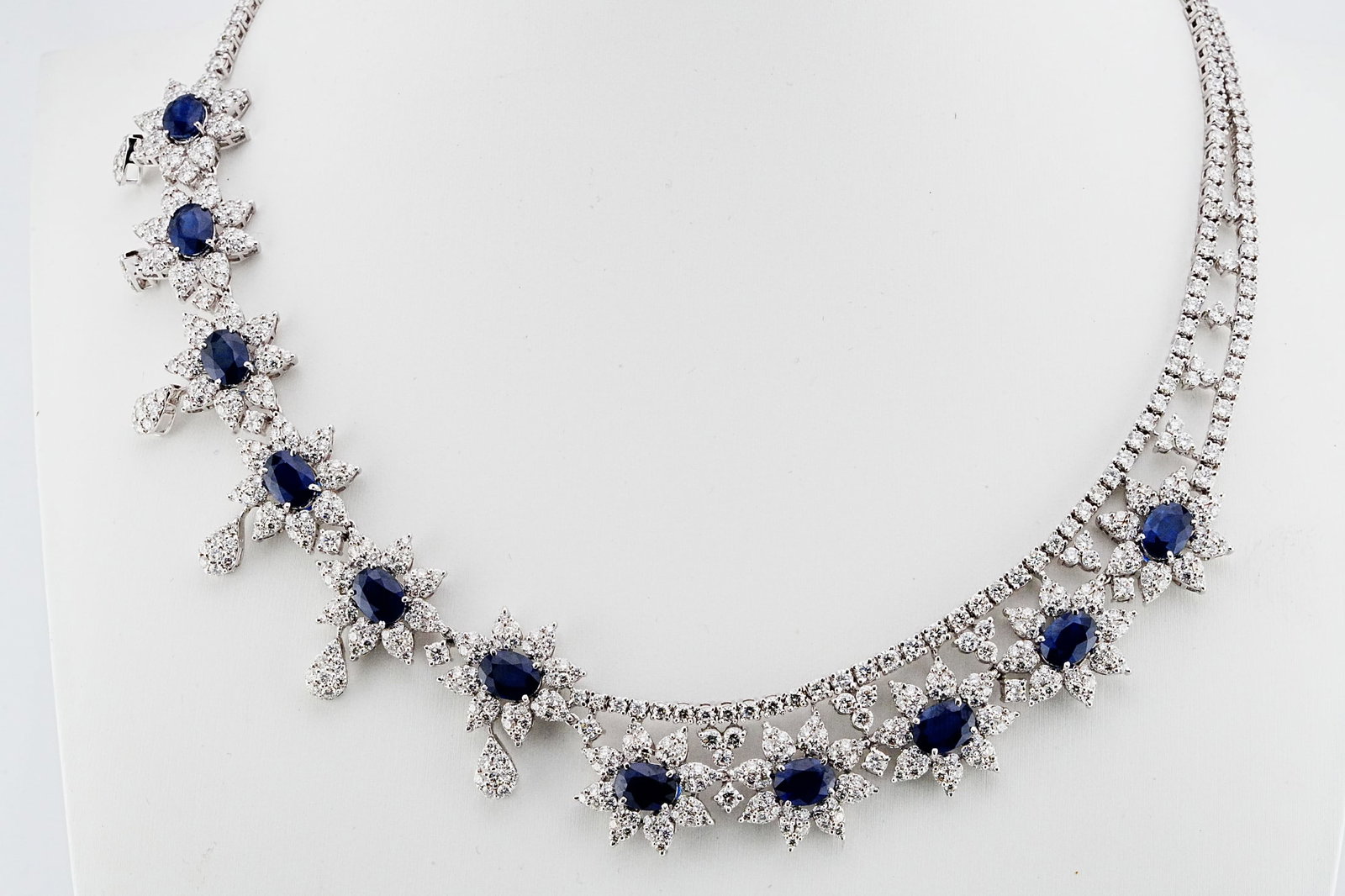 19.30ctw Diamond, 19.00ctw Blue Sapphire, 18K Necklace: 19.30ctw VS1-VS2/G-H Diamond, 19.00ctw Blue Sapphire and 18K White Gold 17" Asymmetrical Cocktail Necklace - THIS ITEM WILL COME WITH A $118,000 INSURANCE VALUATION REPORT. This extraordinary statemen