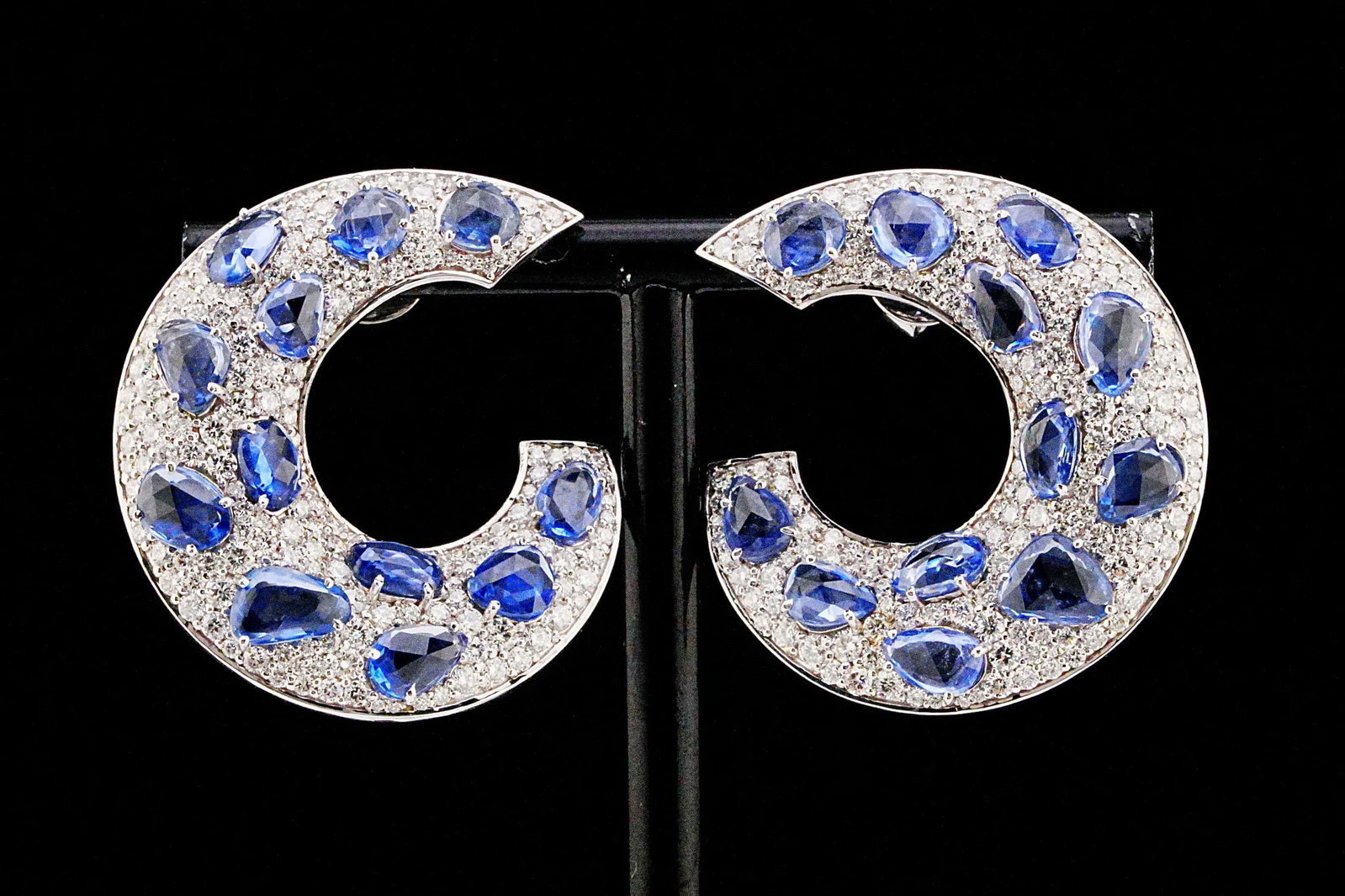 12.20ctw Blue Sapphire, 4.50ctw Diamond, 18K Earrings: 12.20ctw Blue Sapphire, 4.50ctw VS1-VS2/G-H Diamond and 18K White Gold 1.50" Crescent Earrings - THIS ITEM WILL COME WITH A $27,000 INSURANCE VALUATION REPORT. A bold expression of contemporary glamou